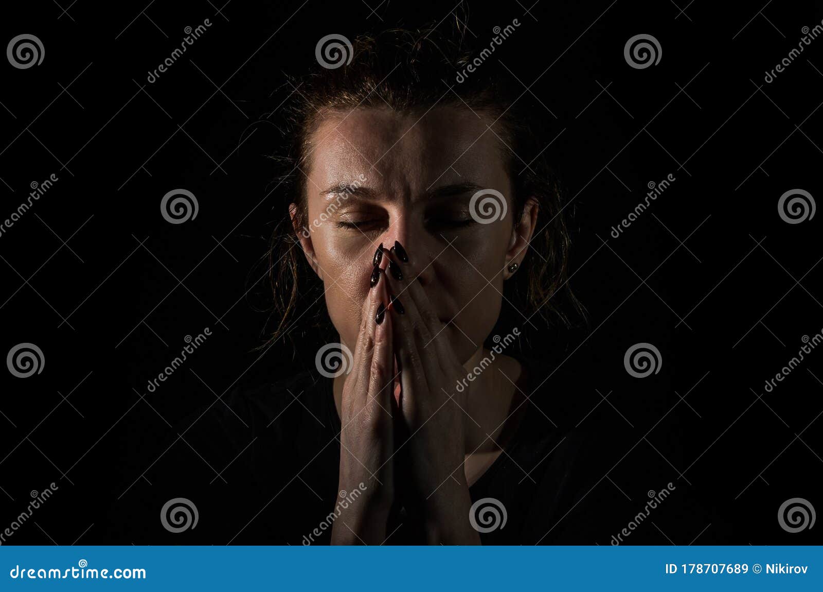 Young Woman Pray In The Dark On A Black Background Stock Image Image