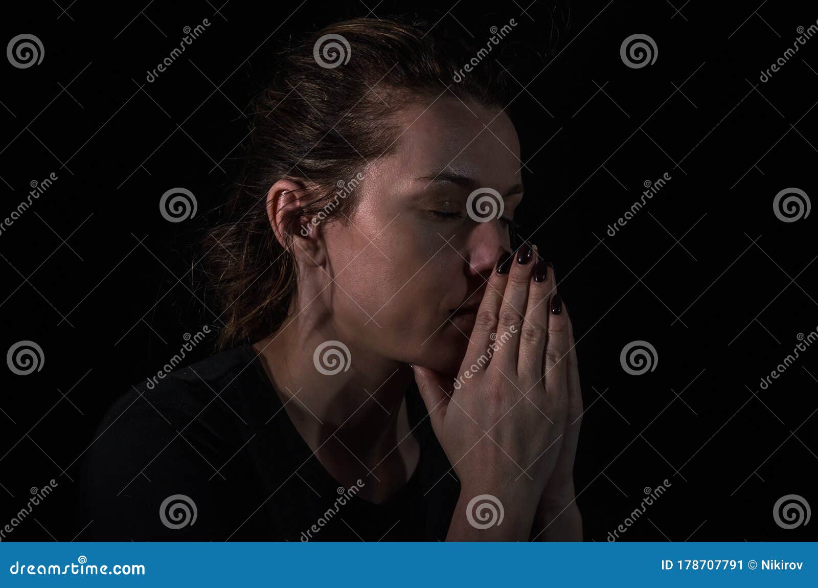 Young Woman Pray in the Dark on a Black Background Stock Image Image