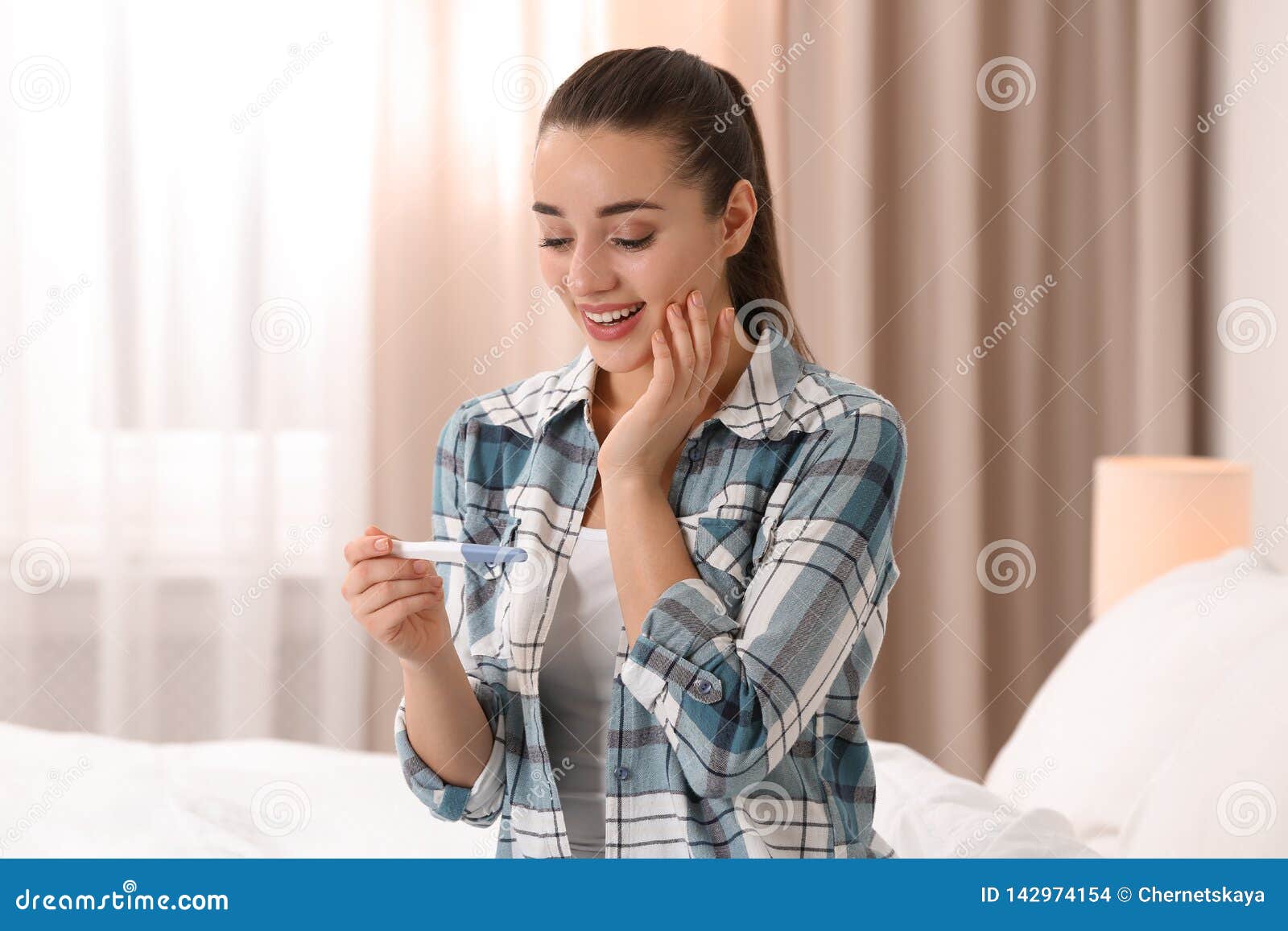 Young Woman With Pregnancy Test At Home Stock Photo - Image of cute, medical: 142974154