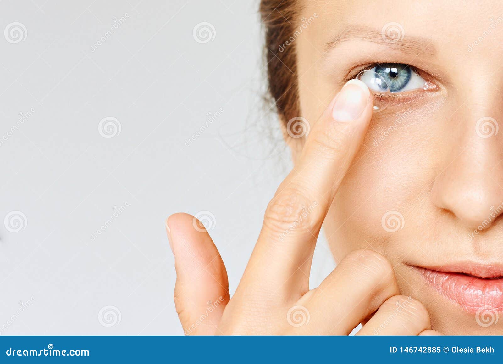 young woman puts contact lens in her eye. eyewear, eyesight and vision, eye care and health, ophthalmology and optometry concept