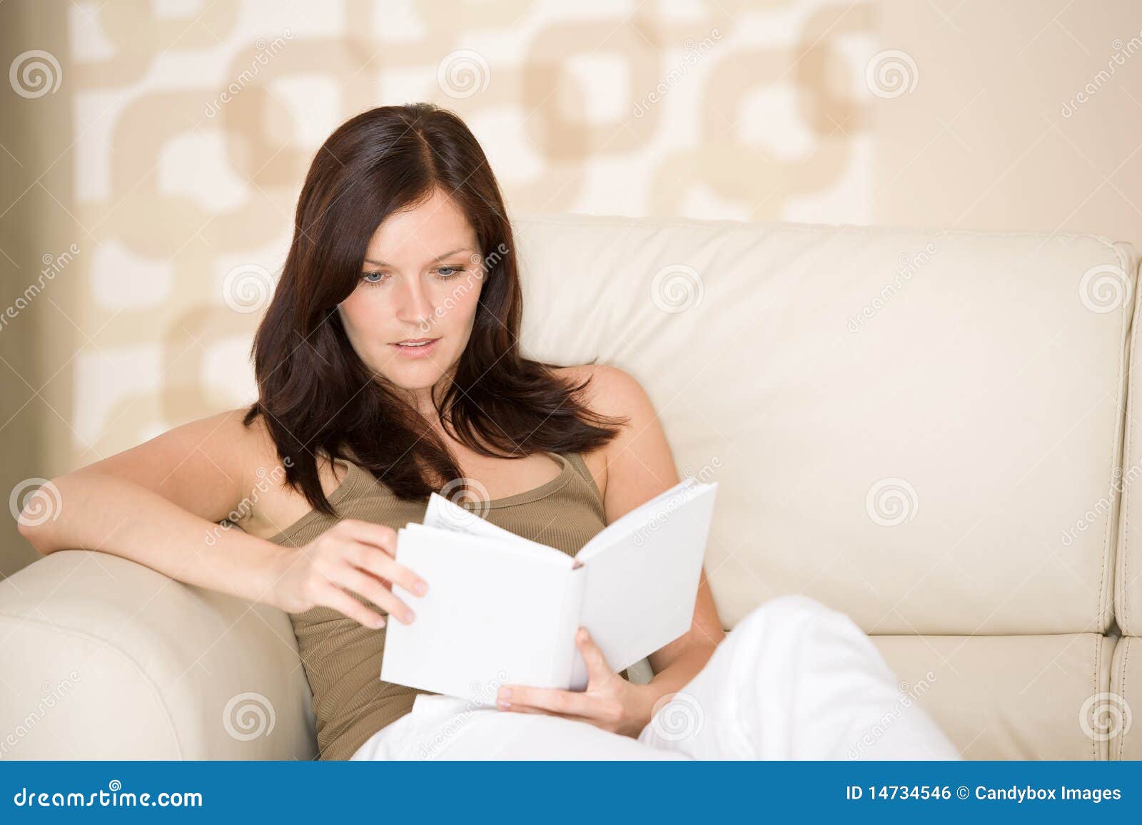 young woman read book relaxing on sofa