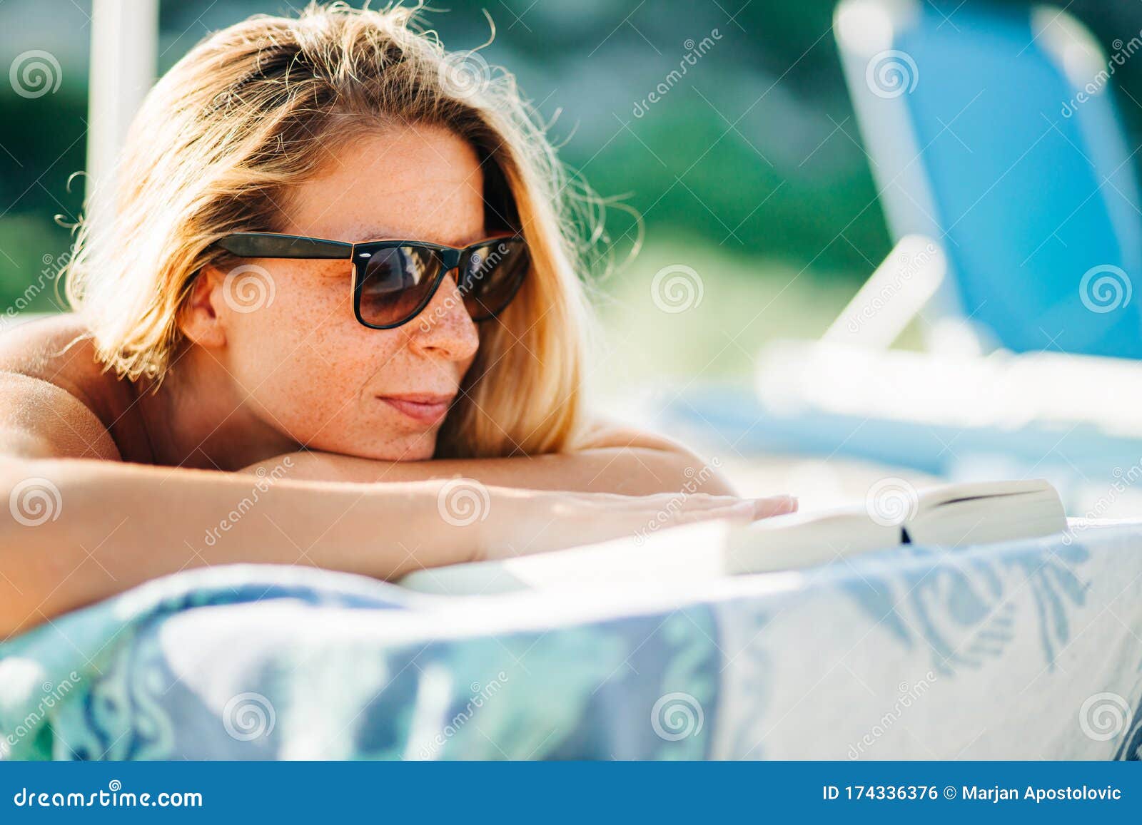 Young Woman Reading a Book Lying on the Beach Stock Photo - Image of ...
