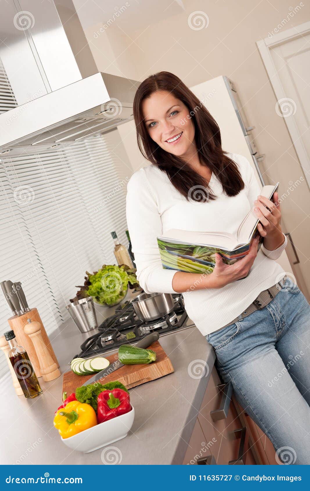 Young Woman Reading Cookbook In The Kitchen Royalty Free ...