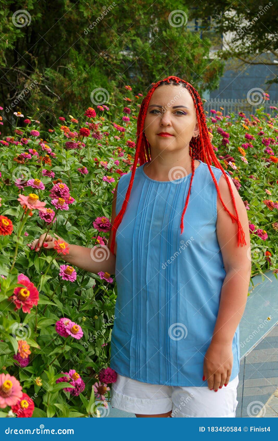 young woman with red hair posing in red orange colors