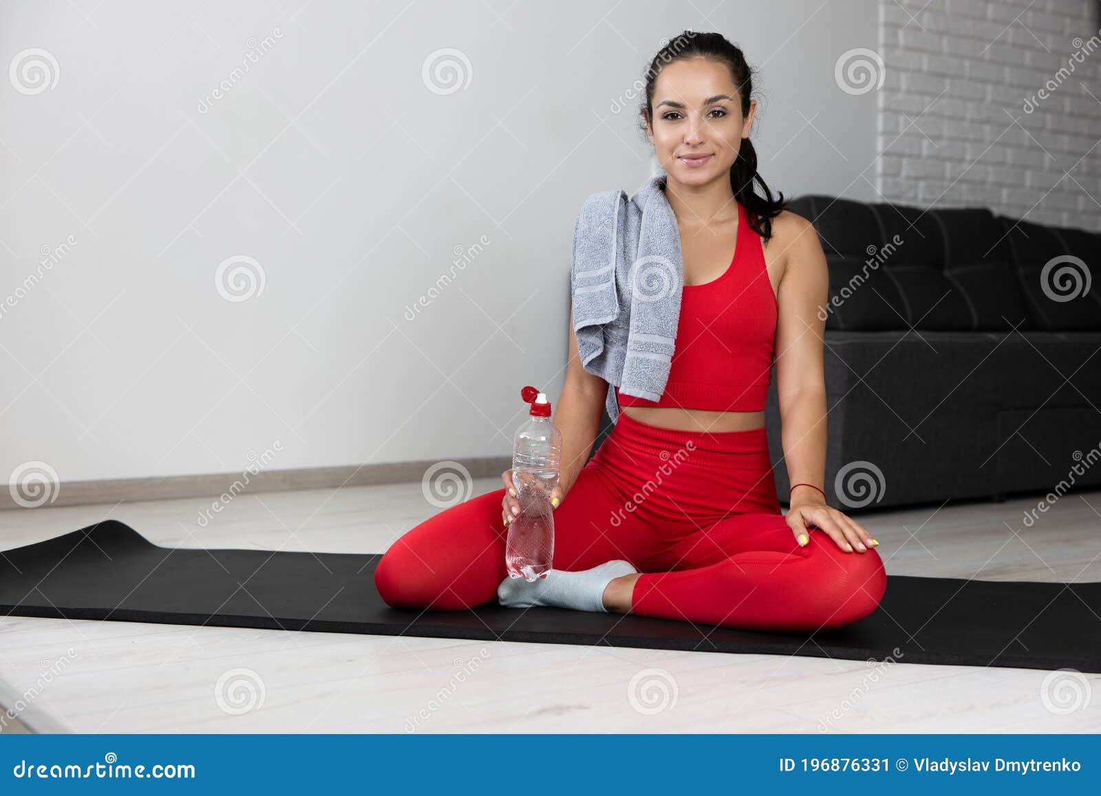 Young Woman in Red Tracksuit Doing Exercise or Yoga at Home. Confident ...