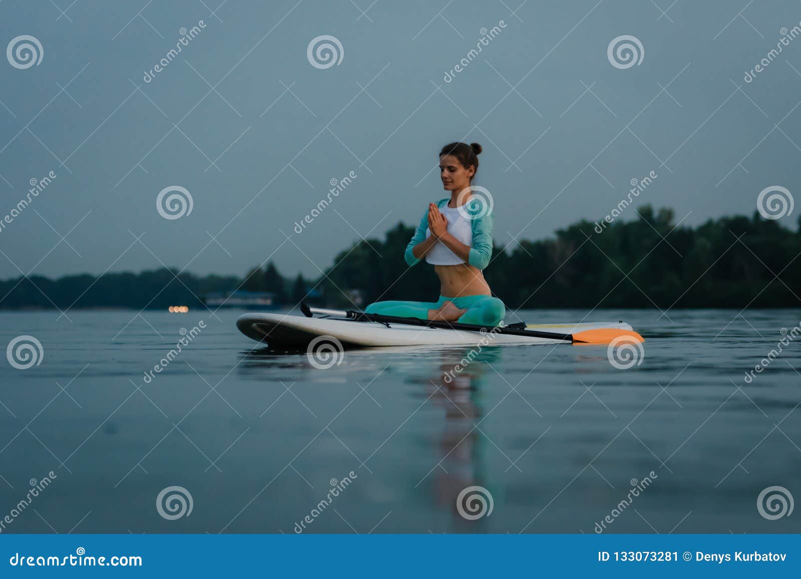 Paddle board yoga stock image. Image of female, flexibility - 133073281