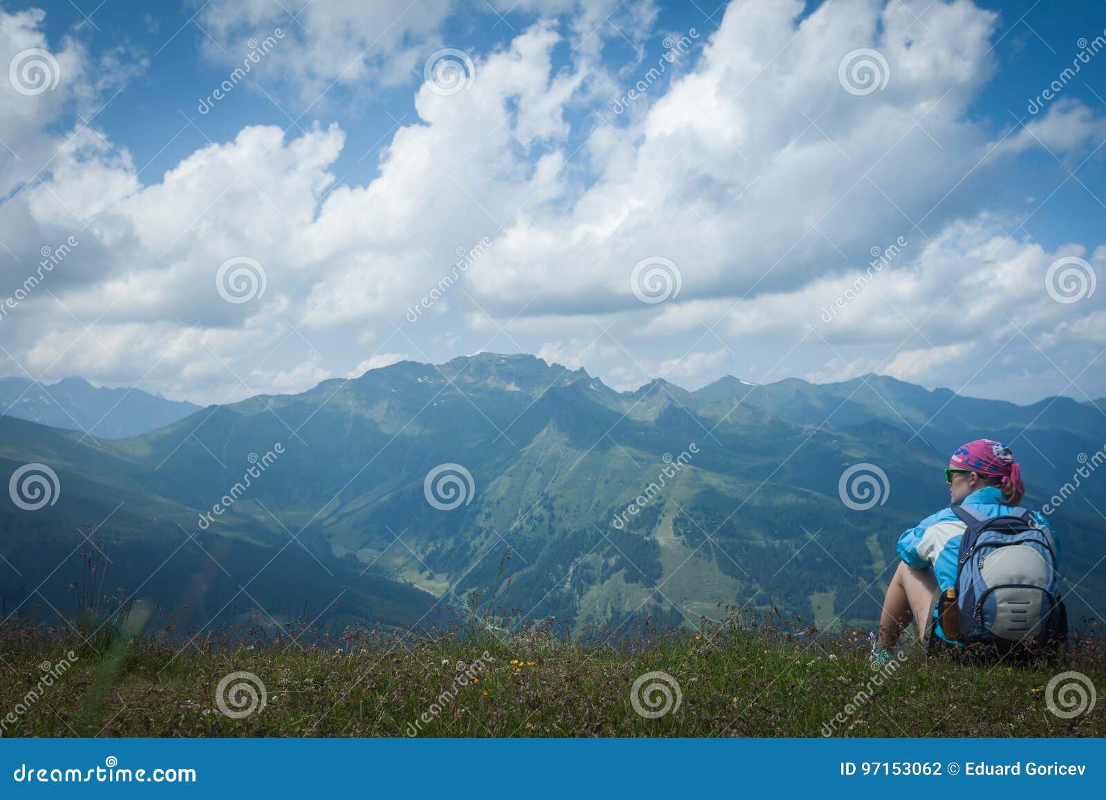 young woman resting on a mountain hike