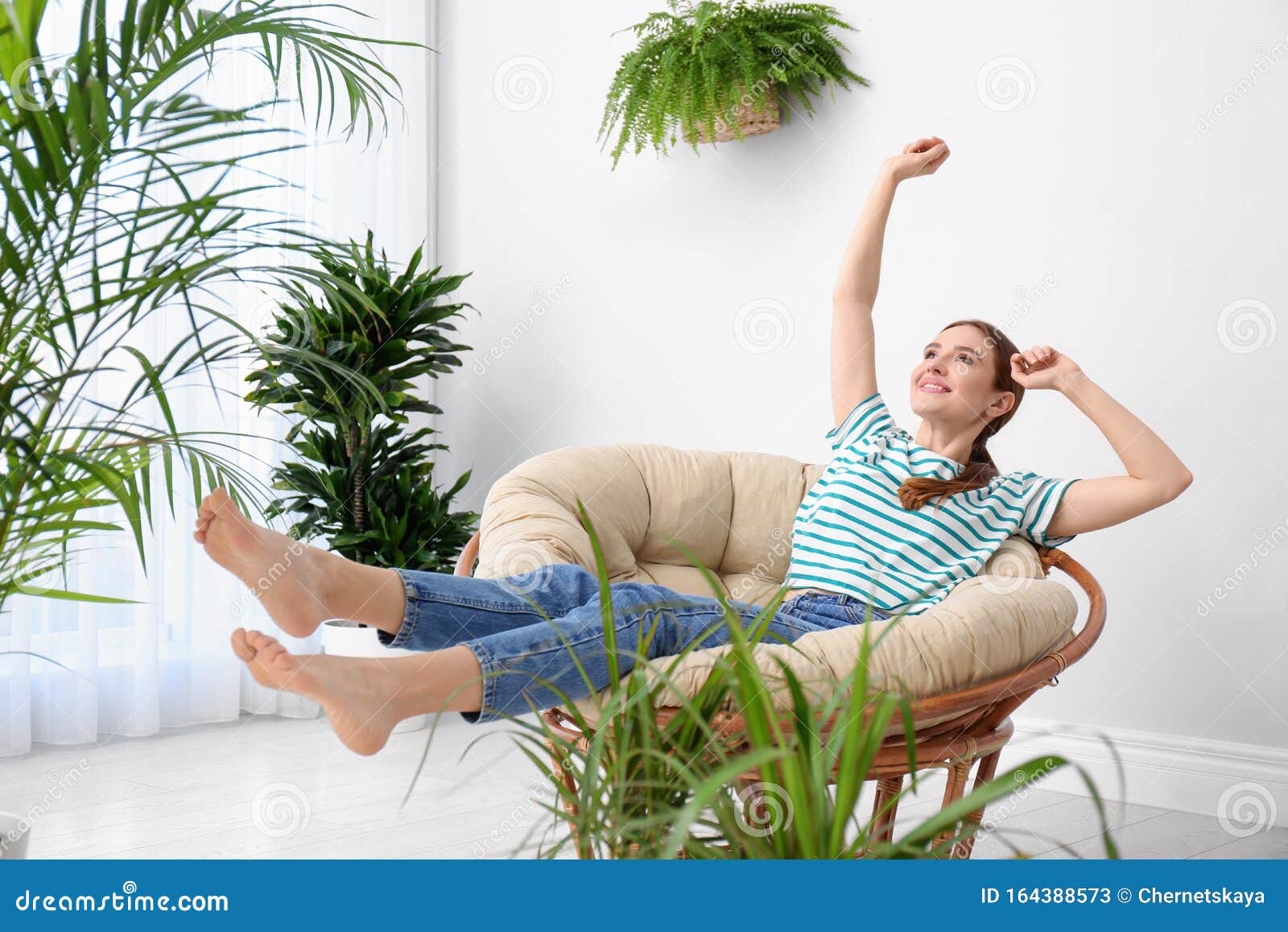 young woman in room decorated with plants