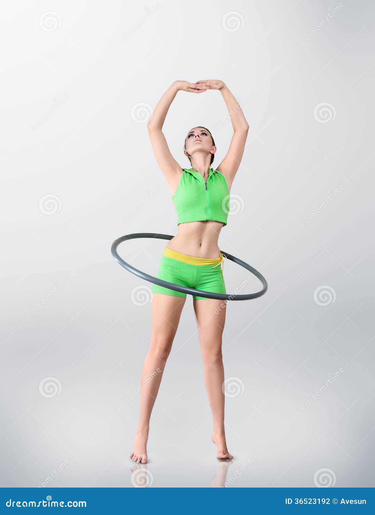young woman rotating hula hoop