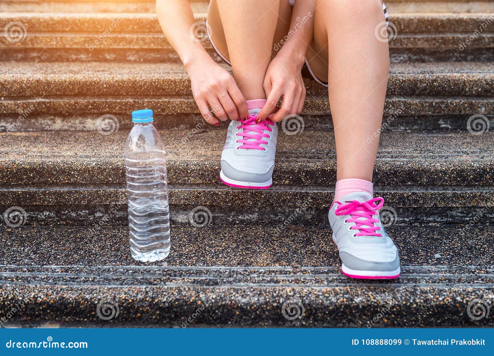 young woman runner tying shoelaces. exercise concept