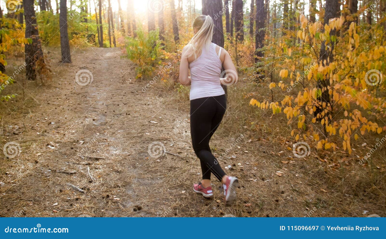 Young Slim Woman Running Up the Hill in Forest Towards Bright Sun Stock ...