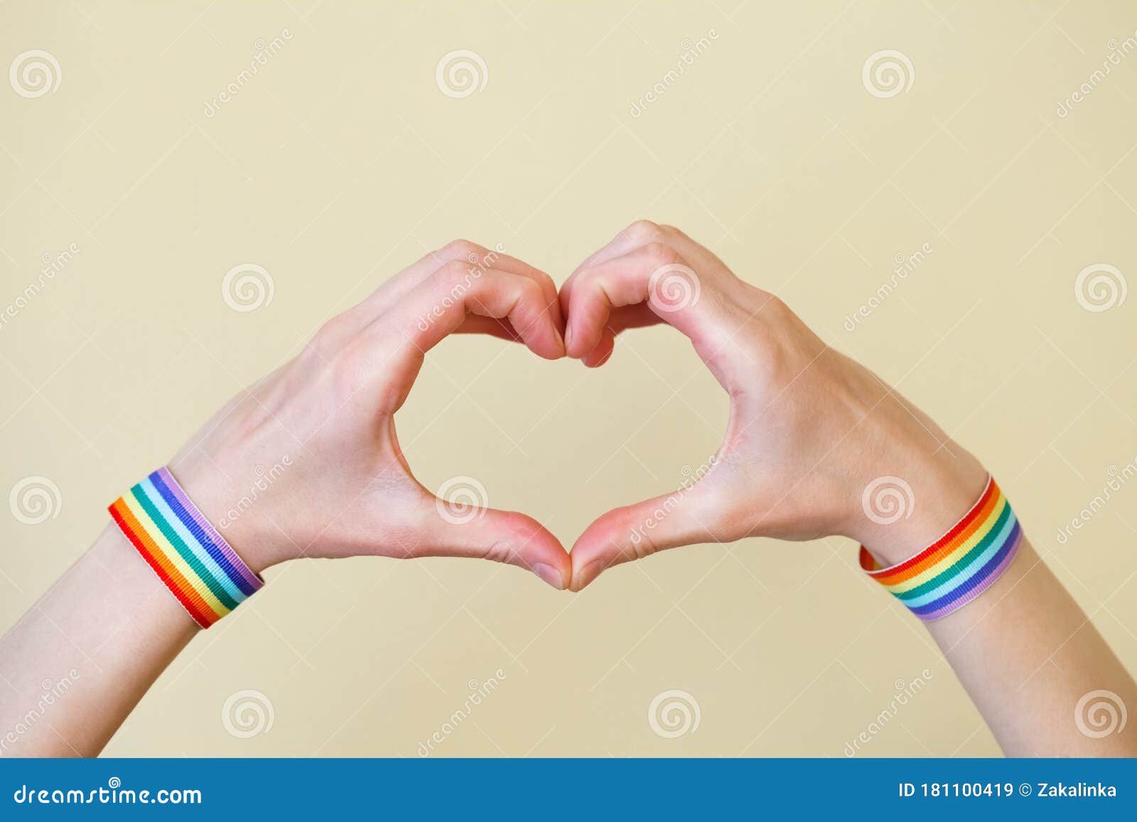 Young Woman`s Hands With Lgbt Colorful Rainbow Flag Wristbands Shaped