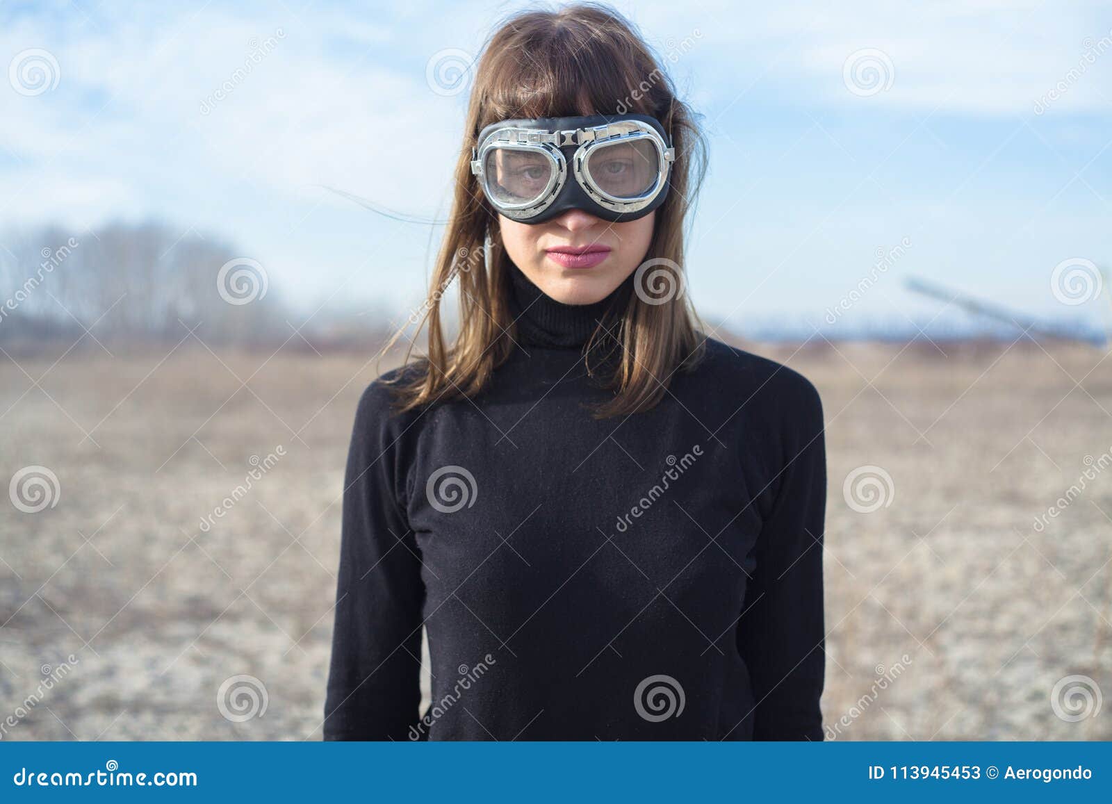 Young Woman with Sand Goggles Standing Alone Stock Image - Image ...