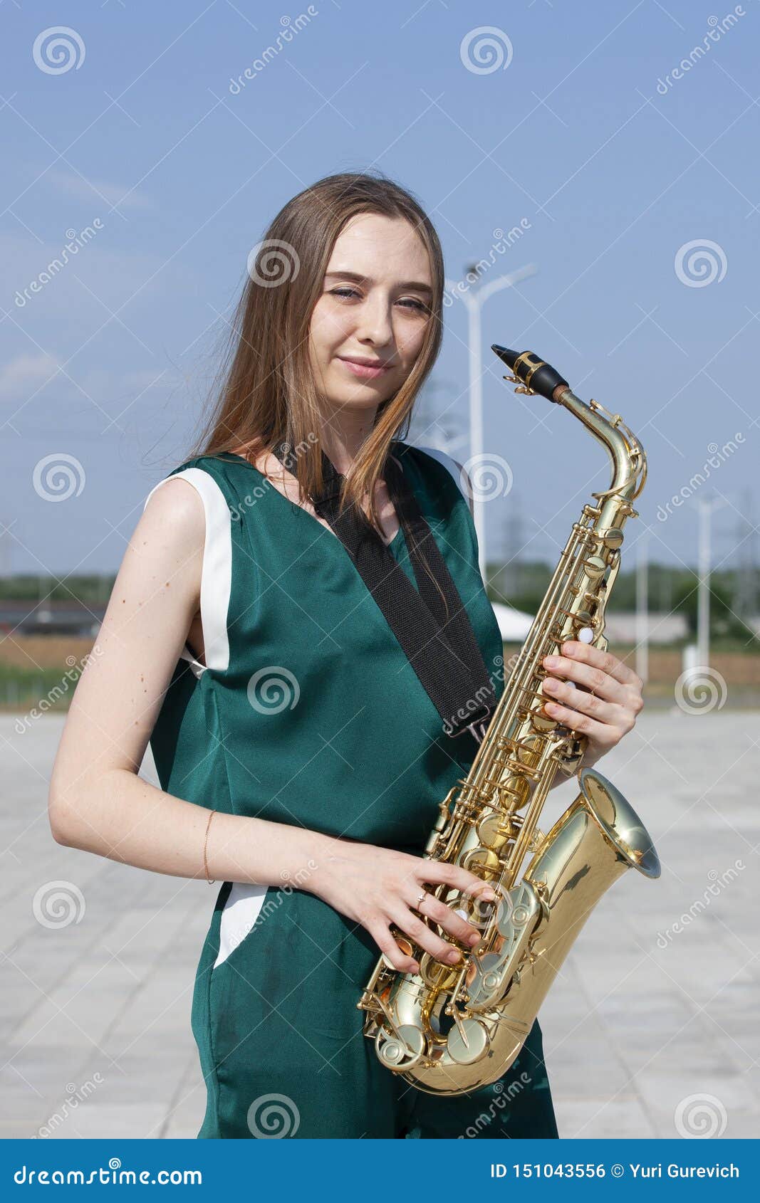 Sexy attractive women with saxophone and long legs posing 