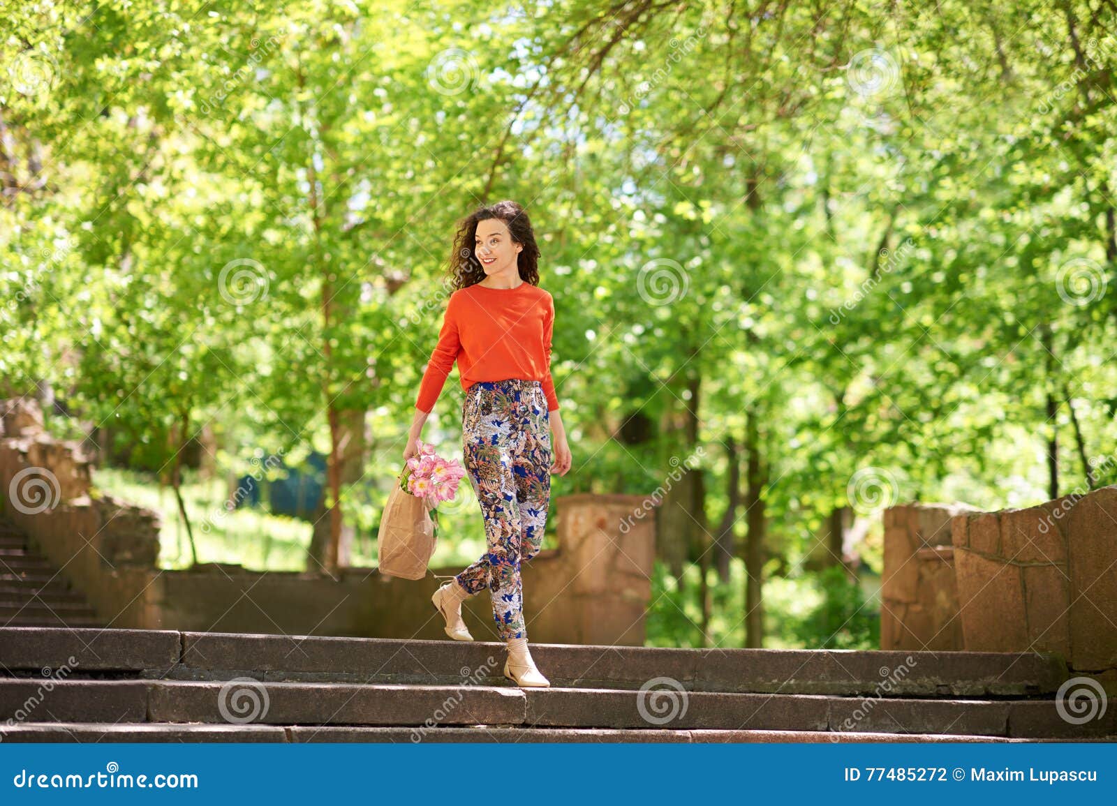 Young Woman with Shopping Bags Walking Down the Stairs Outside Stock ...