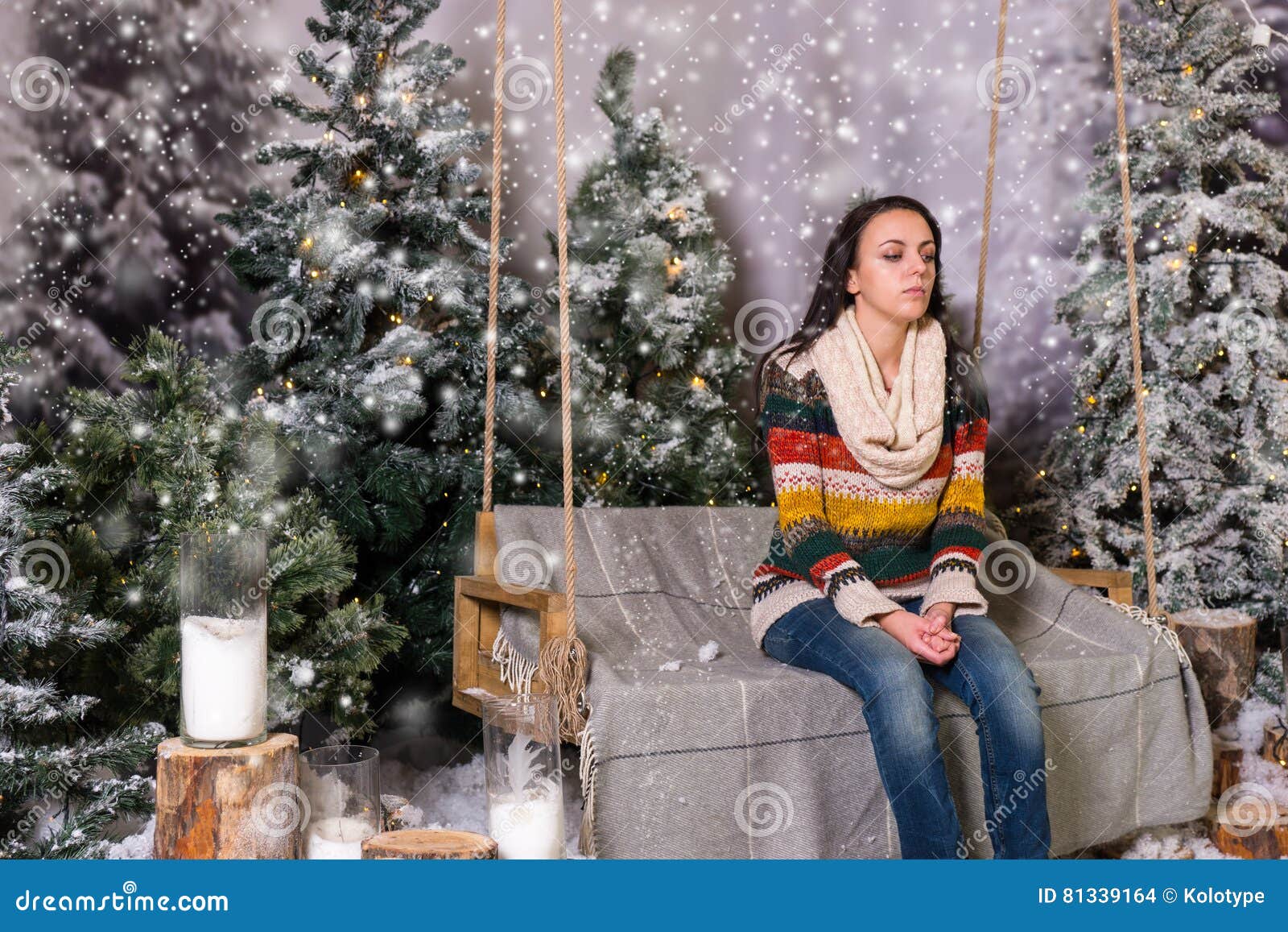 Young Woman Sitting on a Bench or a Swing in a Snow-covered Park Stock ...
