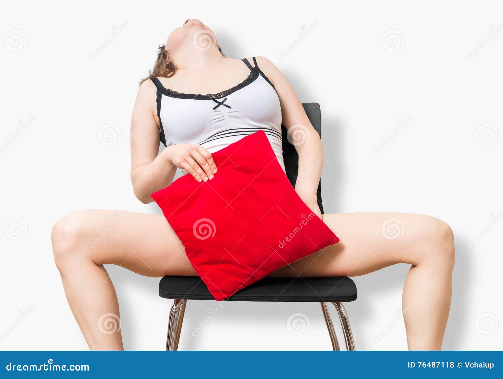 Young Woman is Sitting on Chair, Masturbating and Covering with Red Pillow Stock Photo