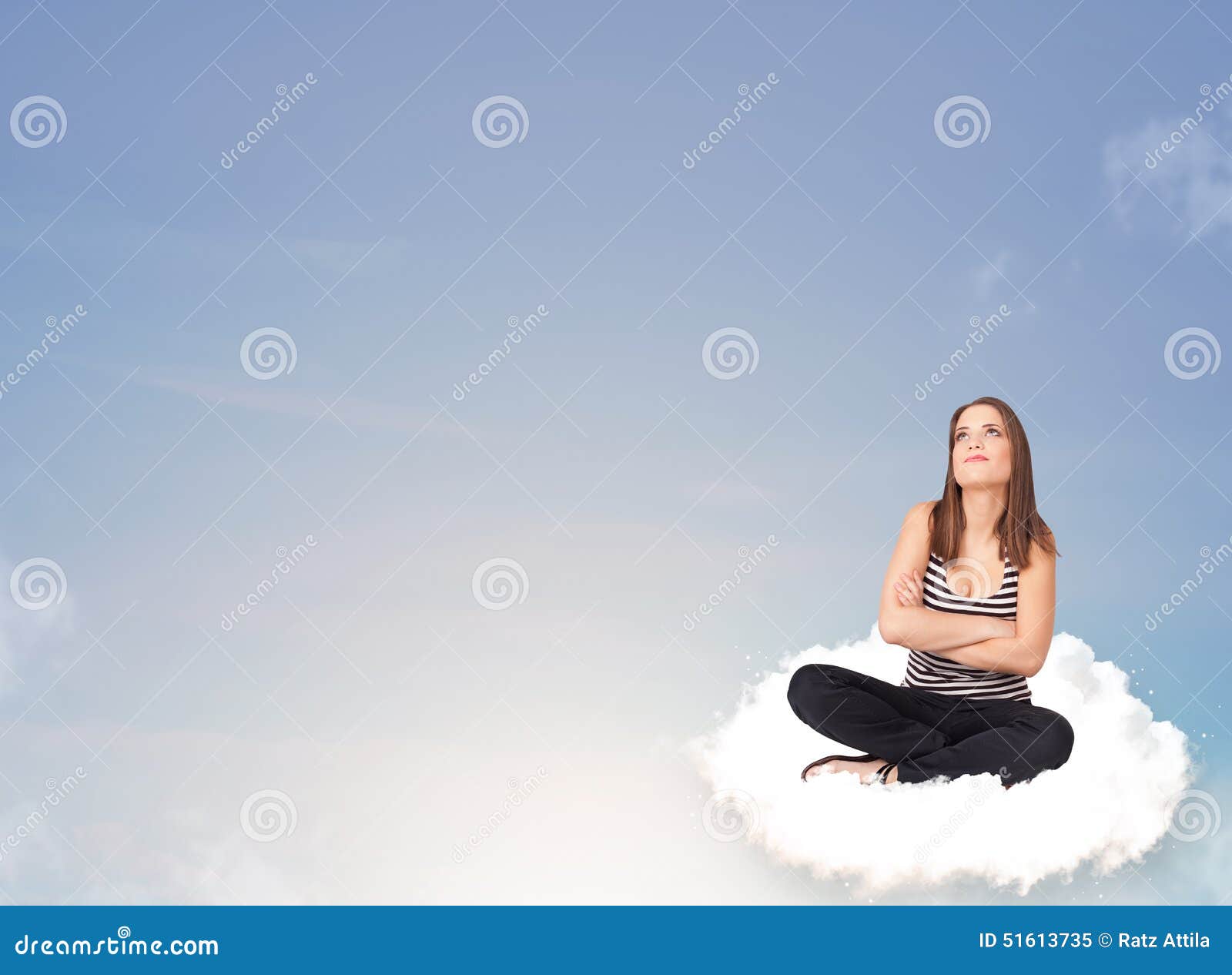 Beautiful young woman sitting on cloud with copy space