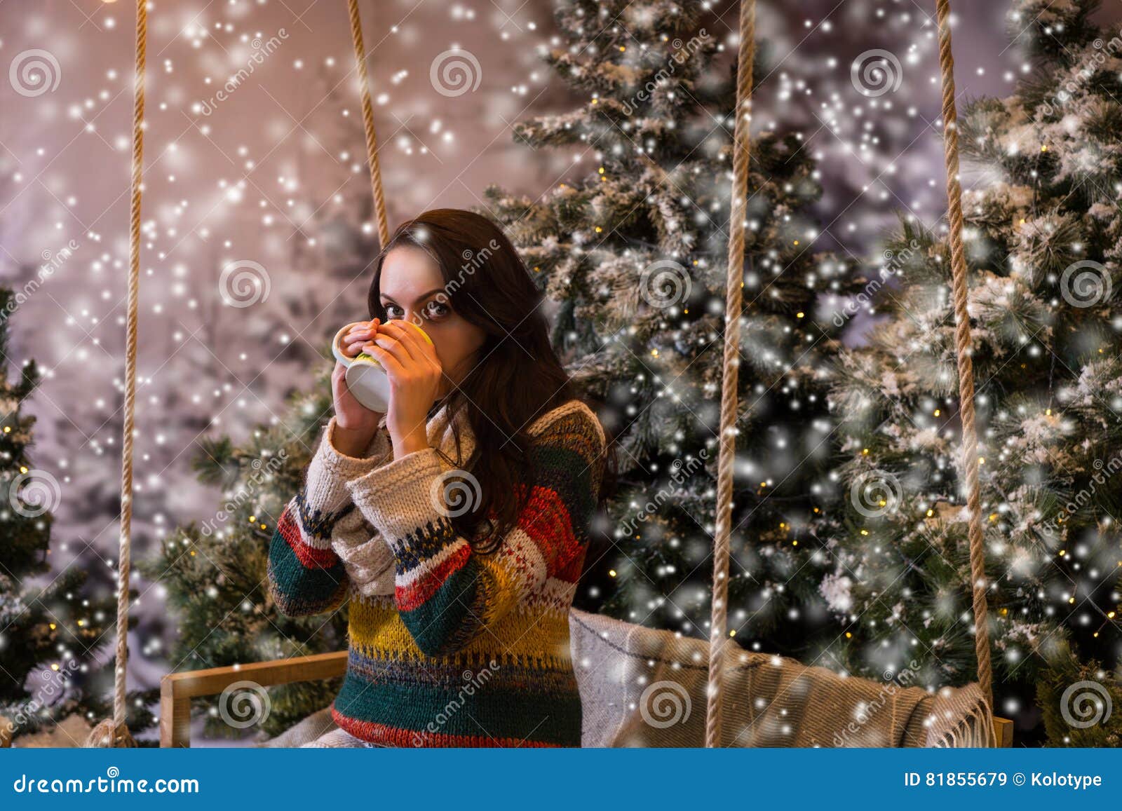 Young Woman Sitting on a Swing and Drinking Hot Drink from a Cup Stock ...