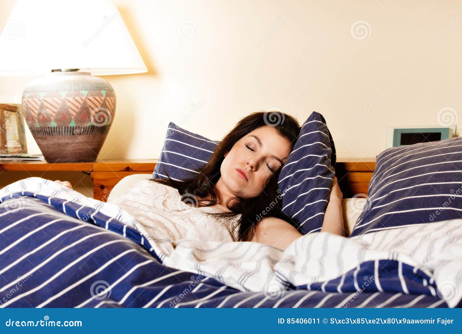 Young Woman Sleeping on the White Bedclothes in Bed Stock Image