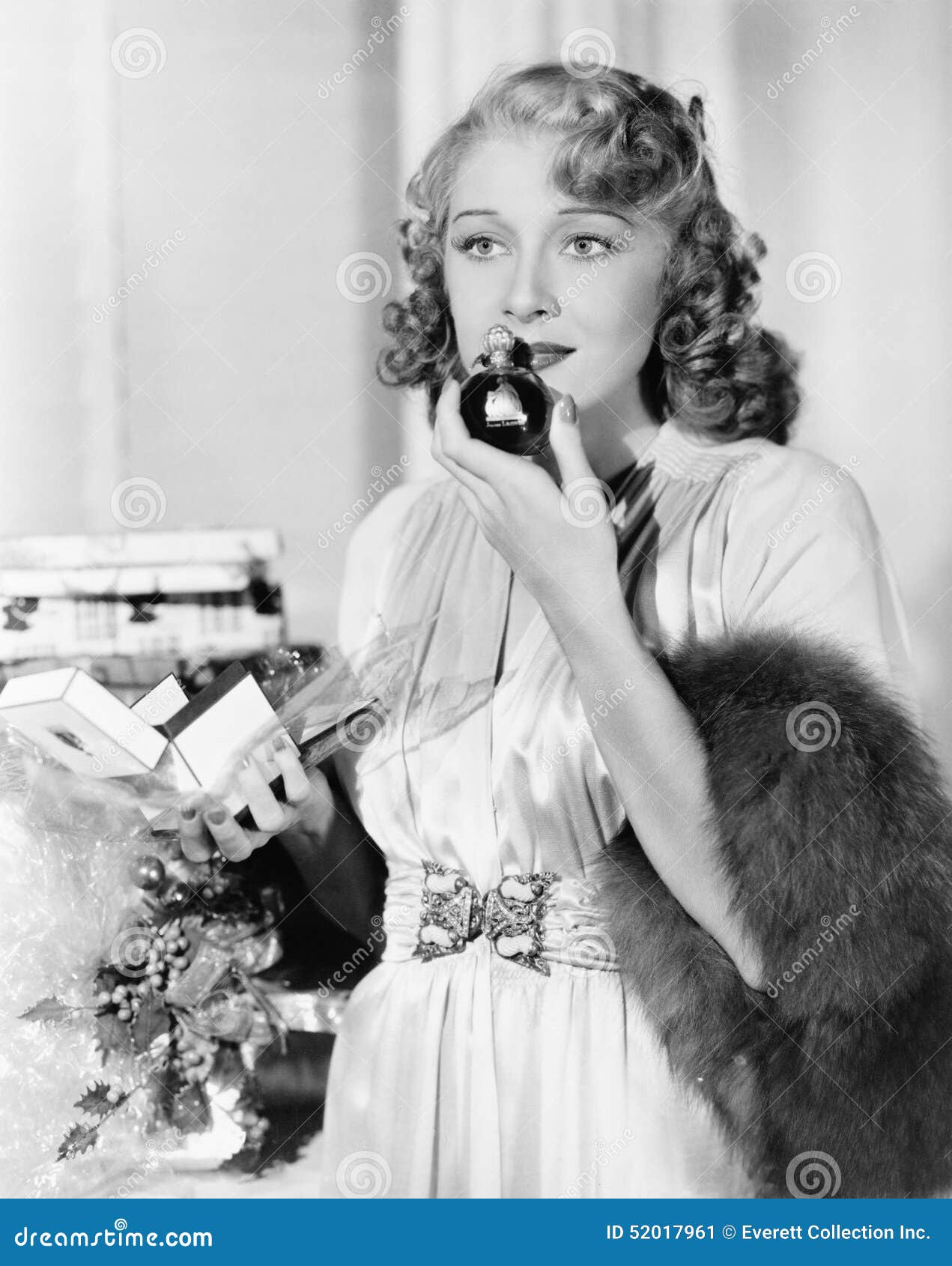 young woman smelling perfume