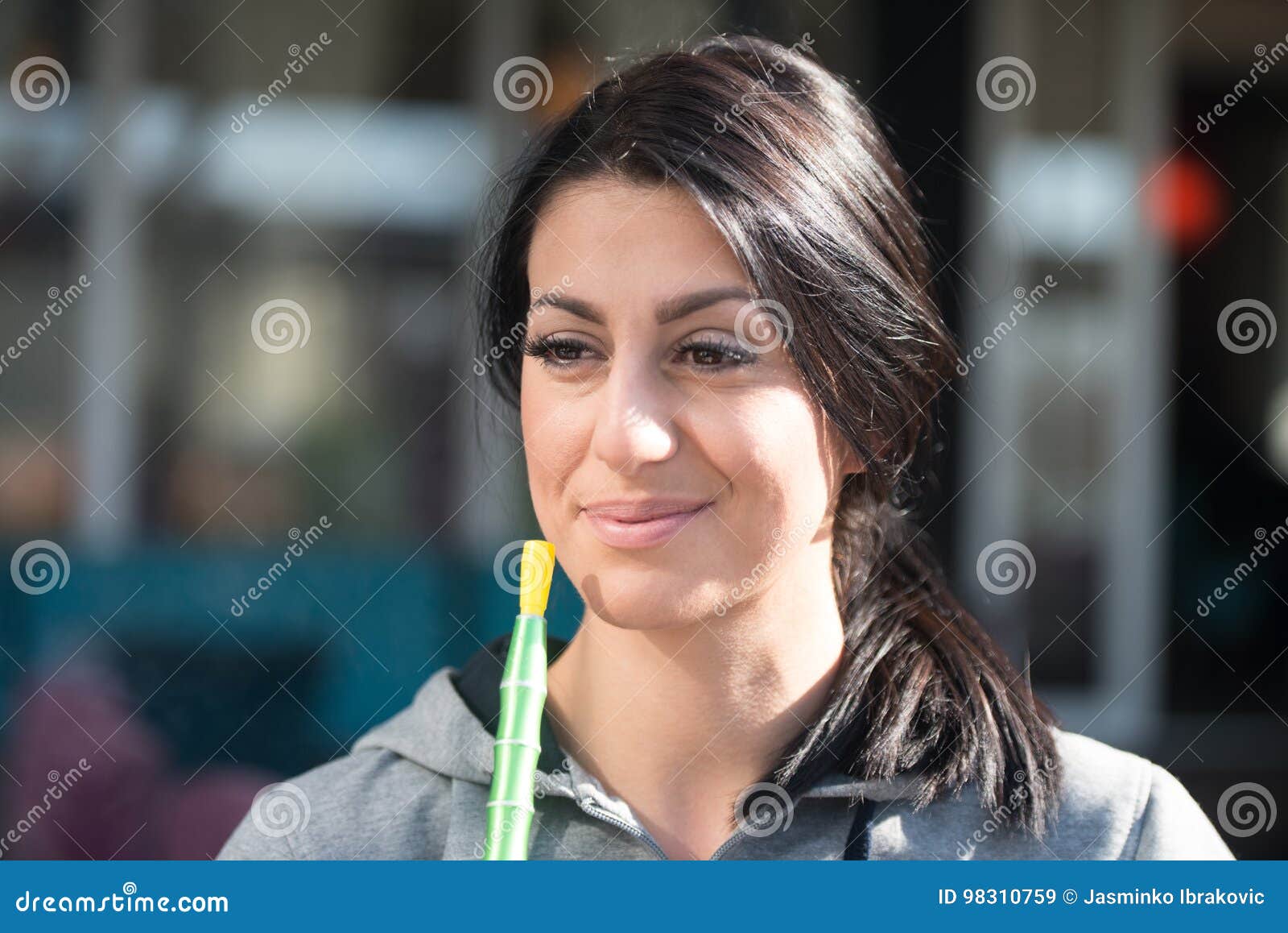 Woman Exhaling Smoke Inhaling From A Hookah Stock Image