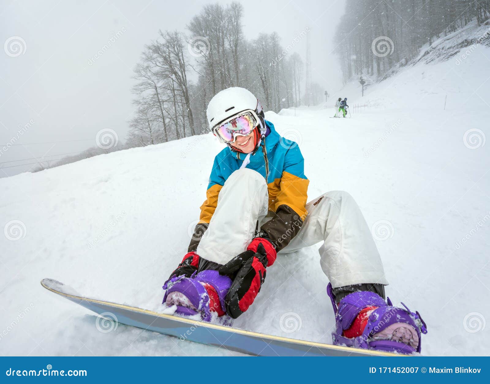 young woman snowboarder in mountains