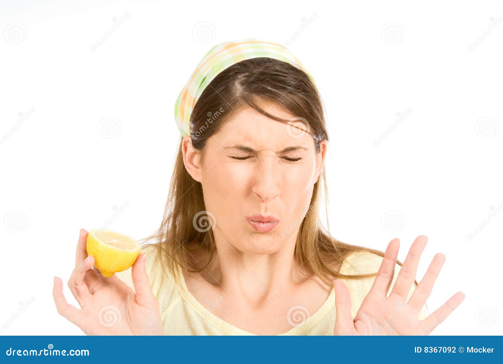 young woman sour grimace with half of lemon