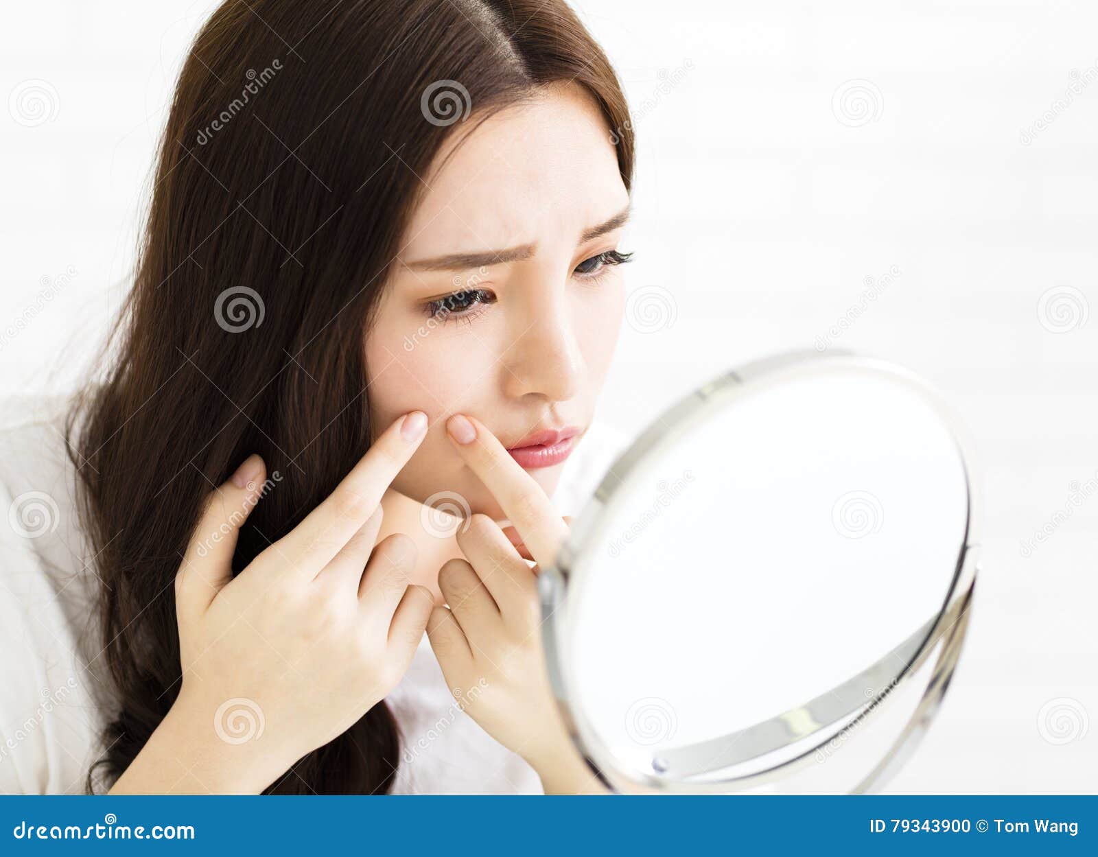 Young Woman Squeeze Her Acne in Front of the Mirror Stock Photo Image