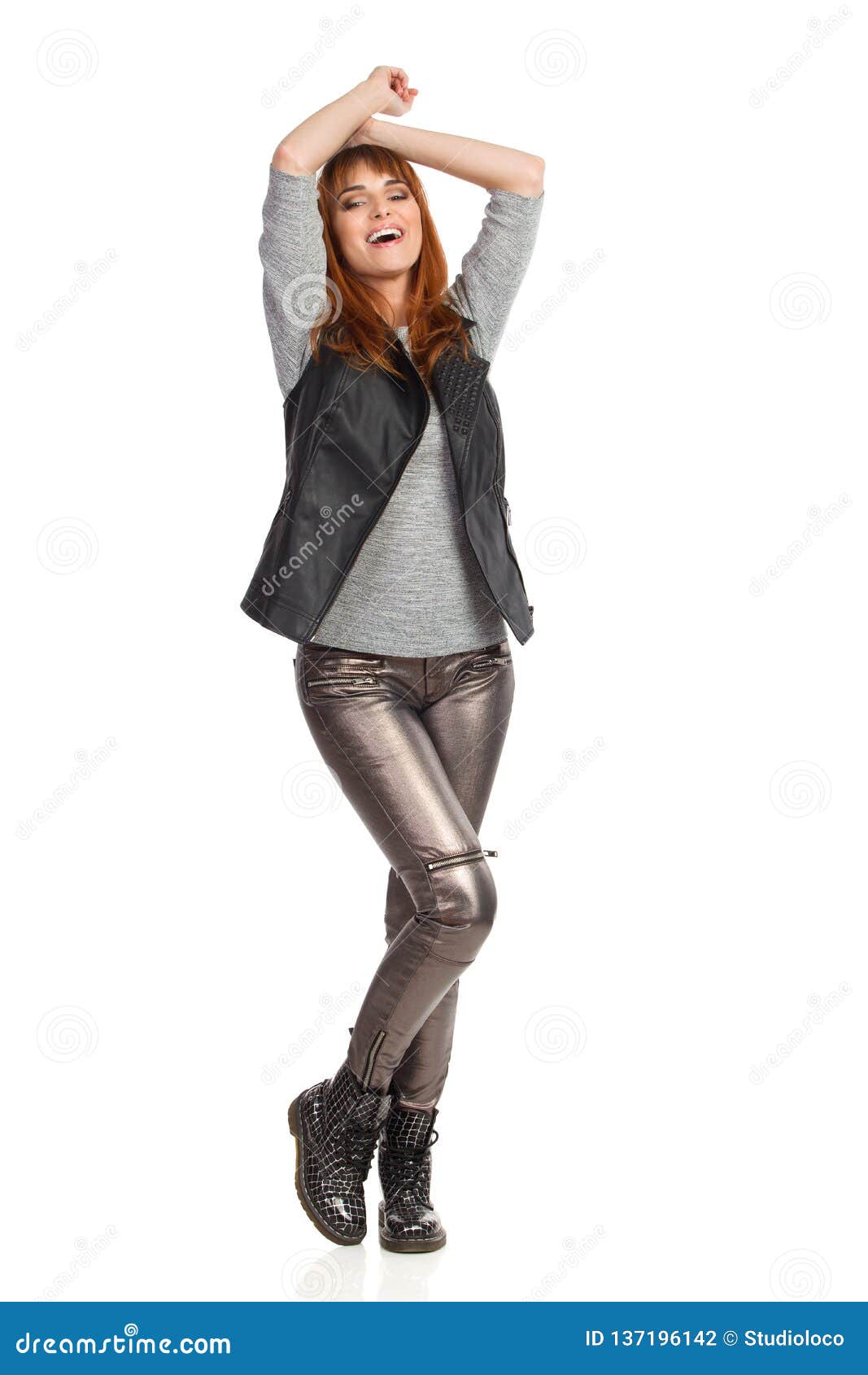 Young Woman is Standing with Arms Raised and Laughing Stock Photo ...