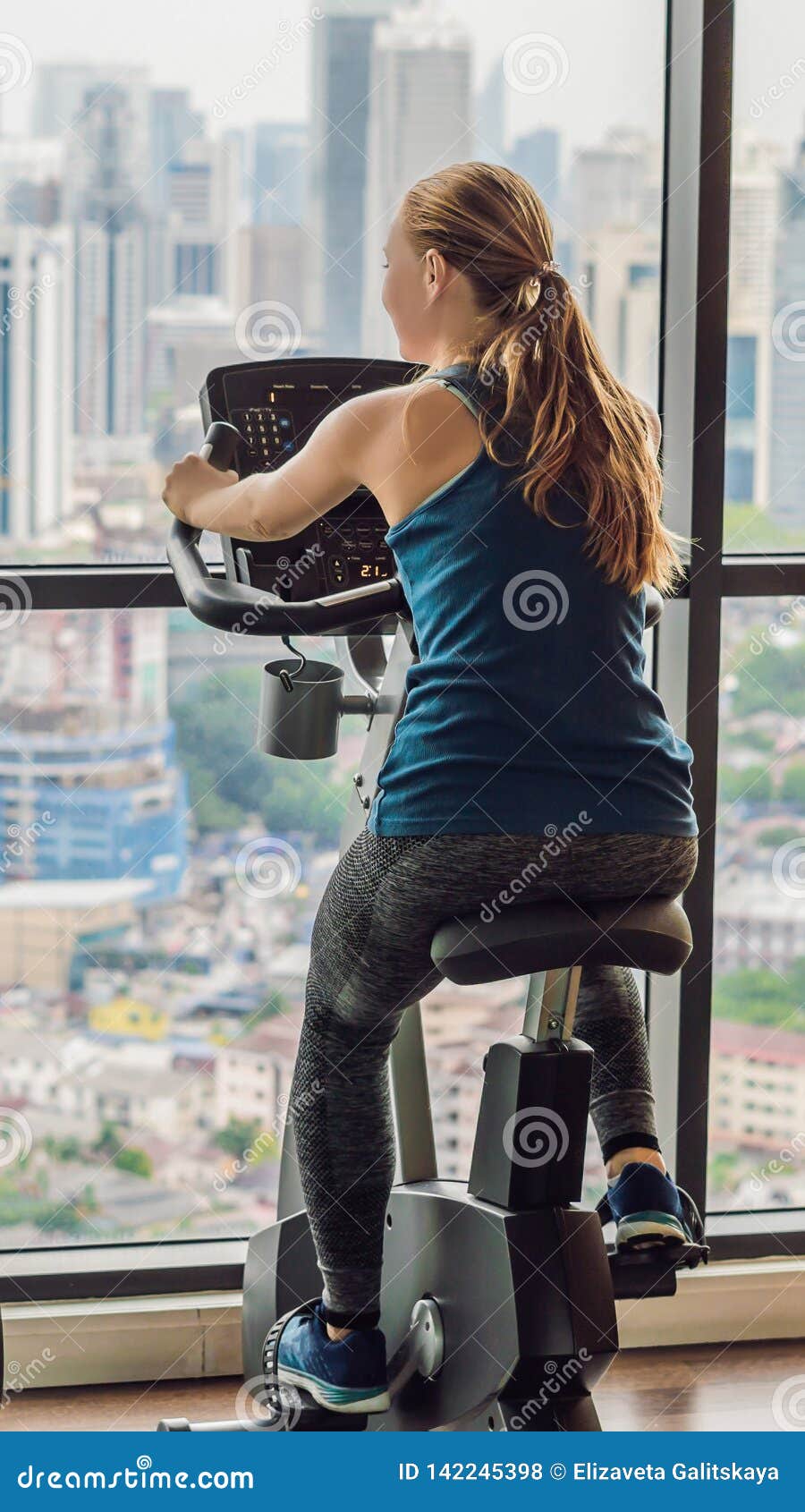 Young Woman on a Stationary Bike in a Gym on a Big City Background VERTICAL  FORMAT for Instagram Mobile Story or Stories Stock Photo - Image of girl,  cardio: 142245398