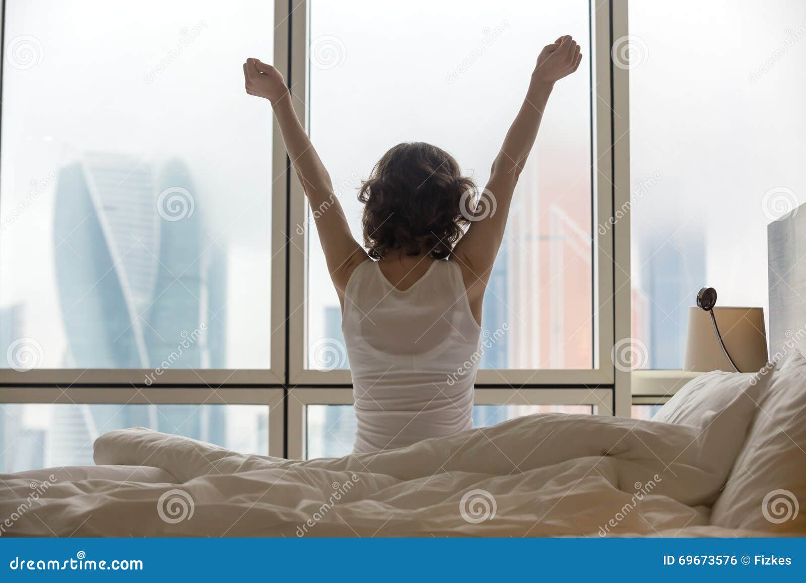 young woman stretching after waking up