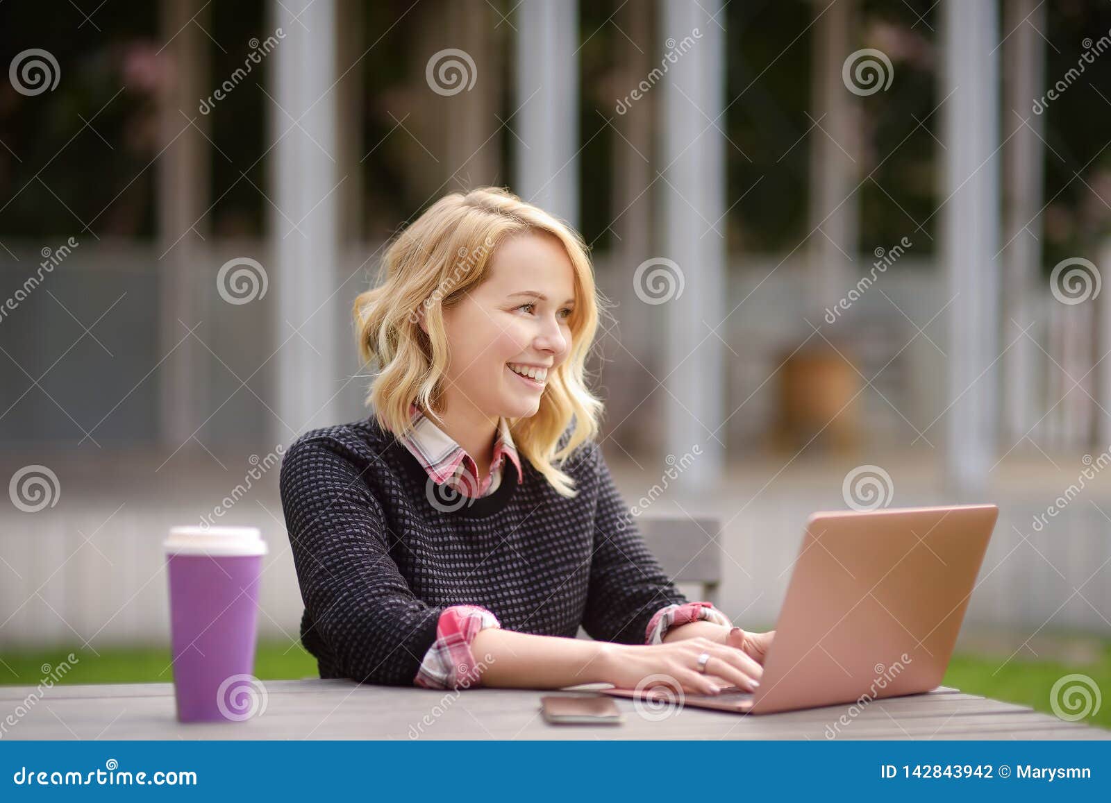 Young Woman Studying/working and Enjoying Beautiful Day Stock Photo