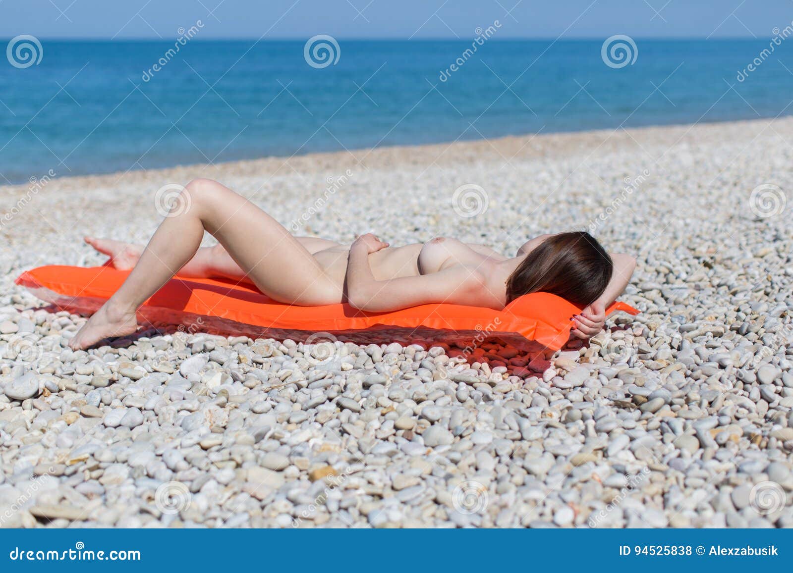 Beach Nude Girls - Young Woman Sunbathes on Pebble Seashore Stock Photo - Image of beach,  caucasian: 94525838