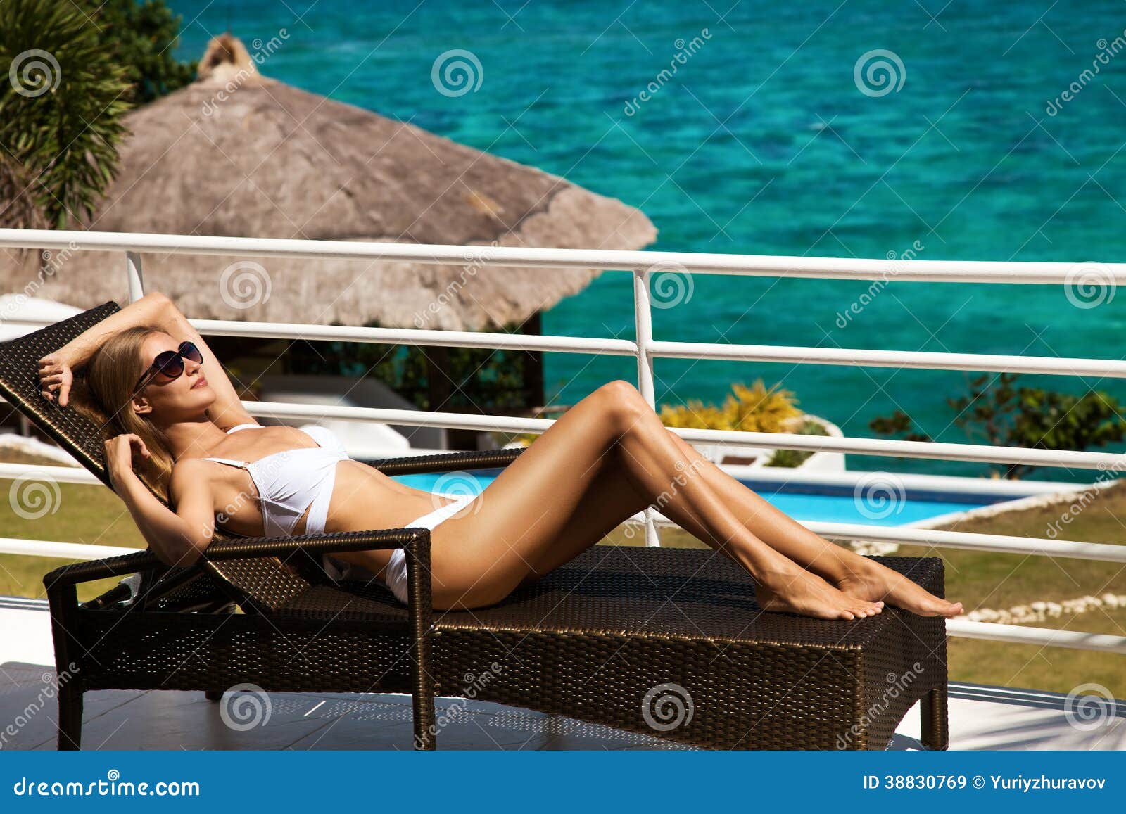 young woman sunbathing on sunbed