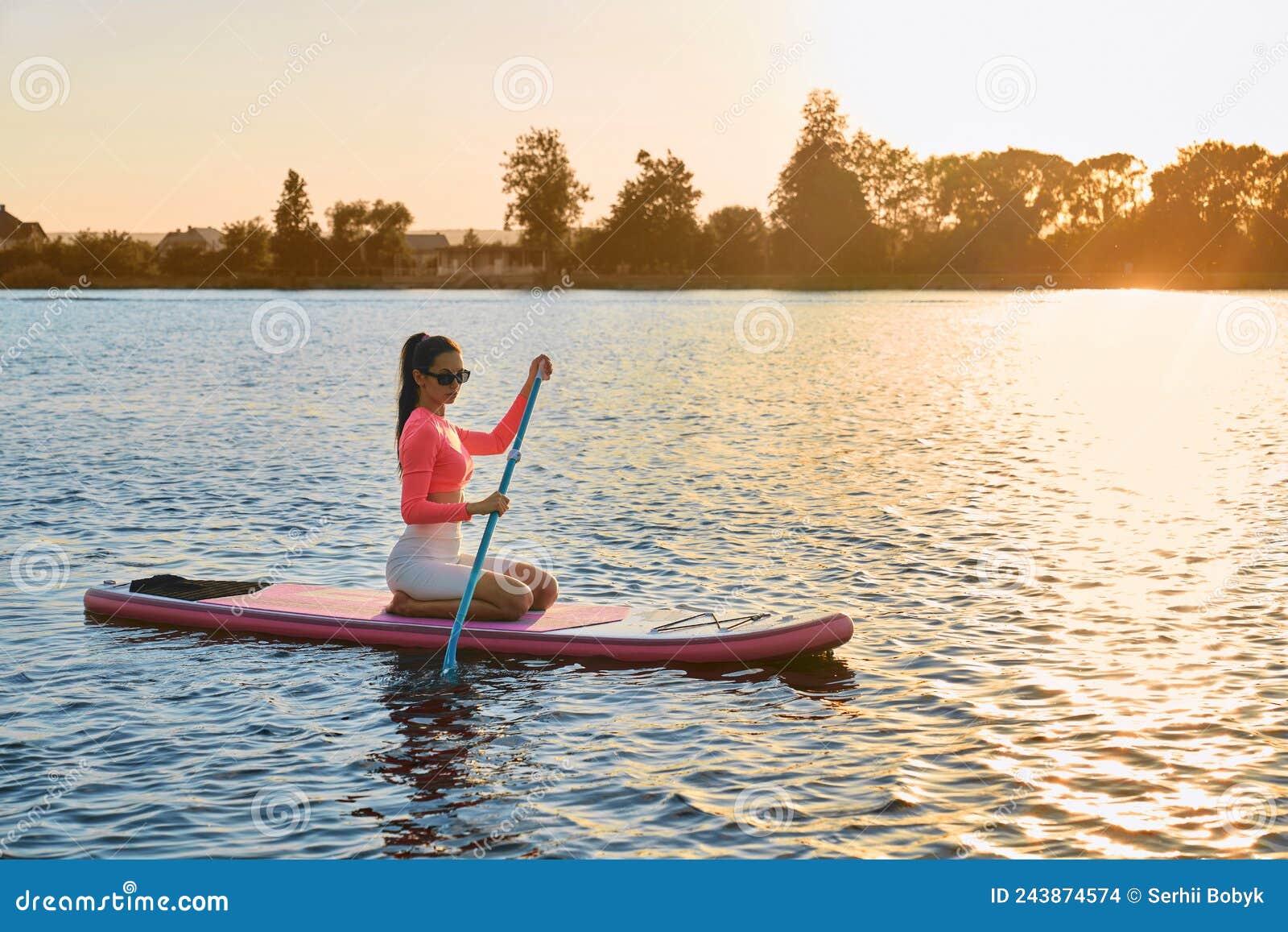Young Woman Swimming on Sup Board during Sunset Stock Photo - Image of ...