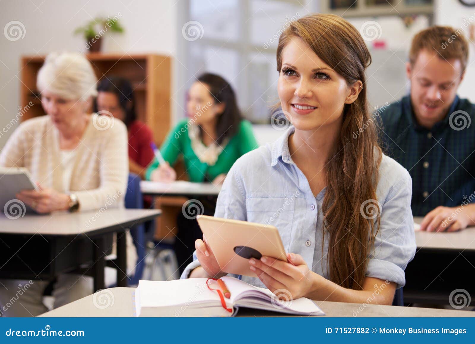 young woman with tablet computer at an adult education class