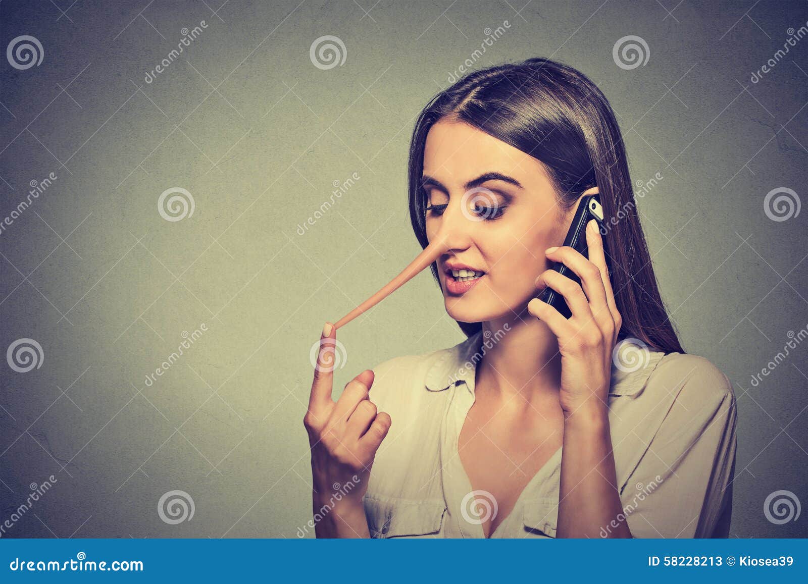 young woman talking on mobile phone telling lies has a long nose