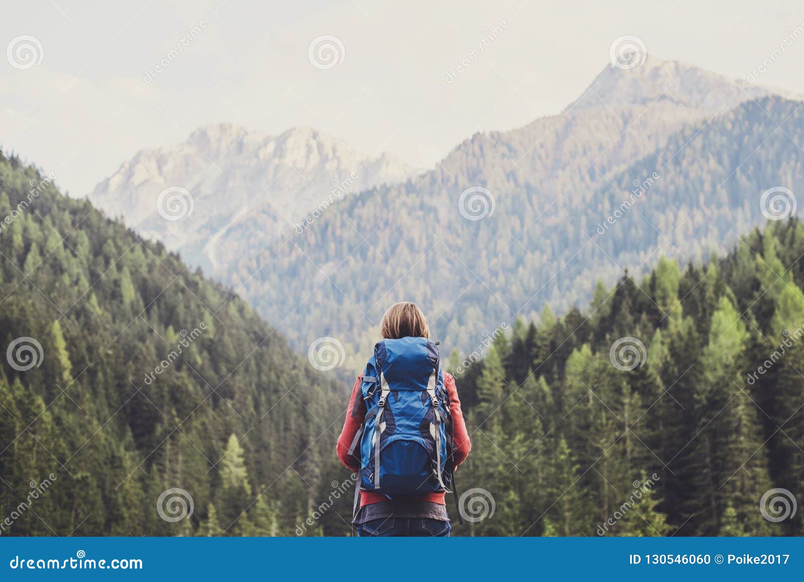 young woman traveler in alps mountains. travel and active lifestyle concept