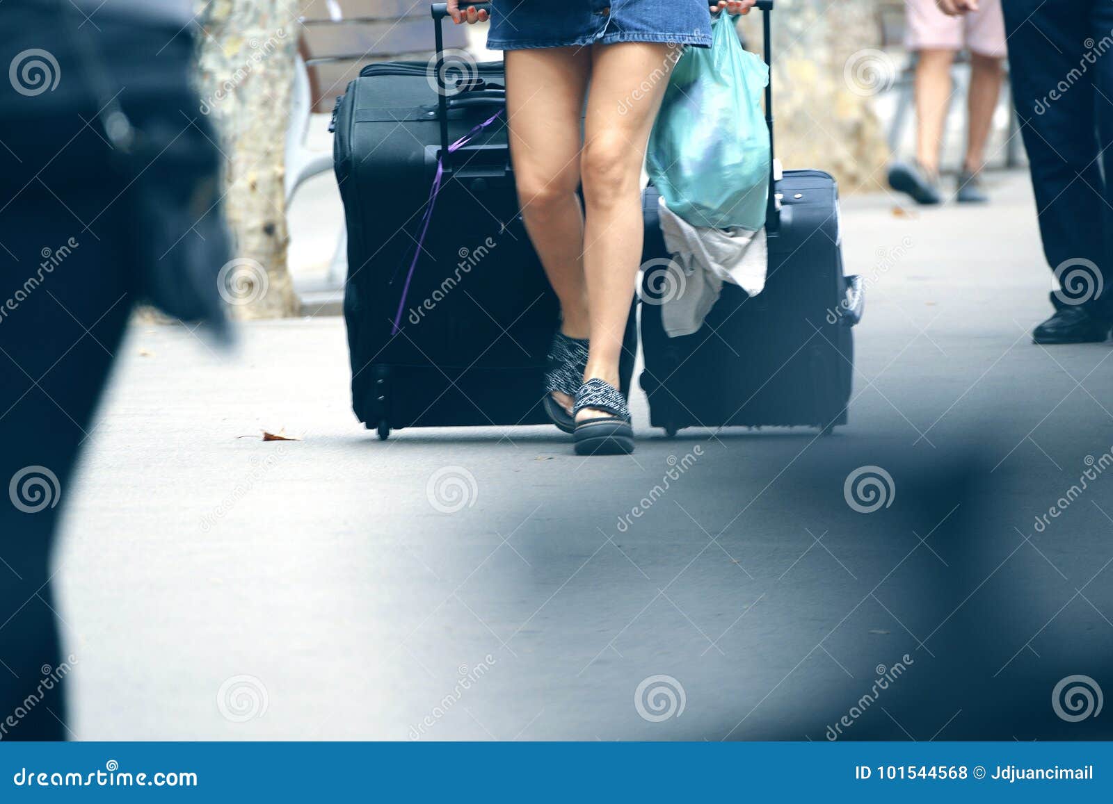 young woman traveling alone carrying some baggage.
