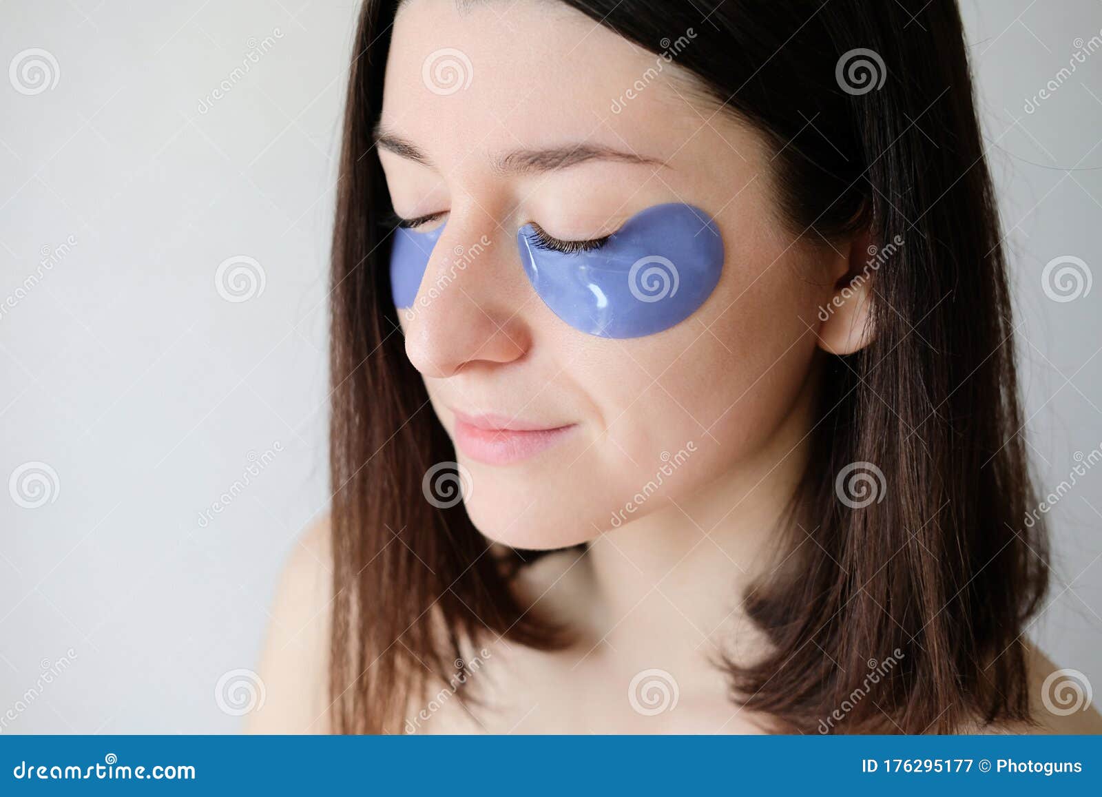 young woman with under eye patches in her face. collagen eye mask for puffiness, close-up view. facial skin care and beauty