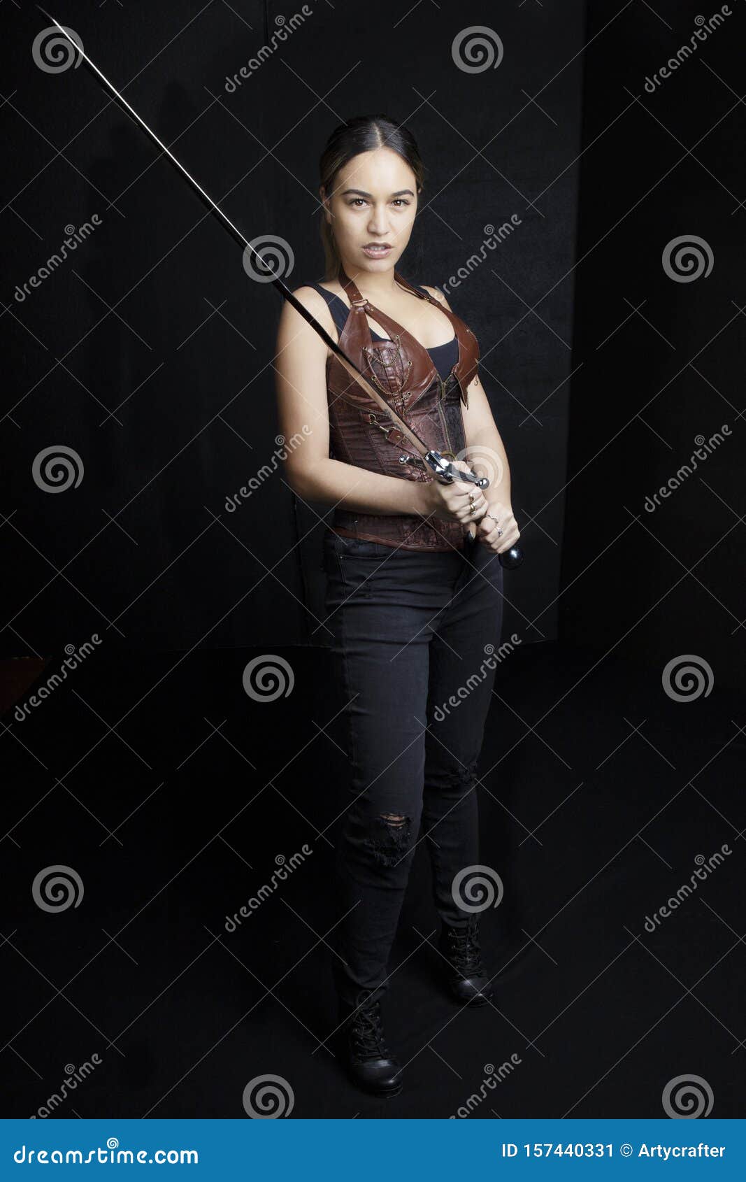 young woman in urban fantasy poses on a black background
