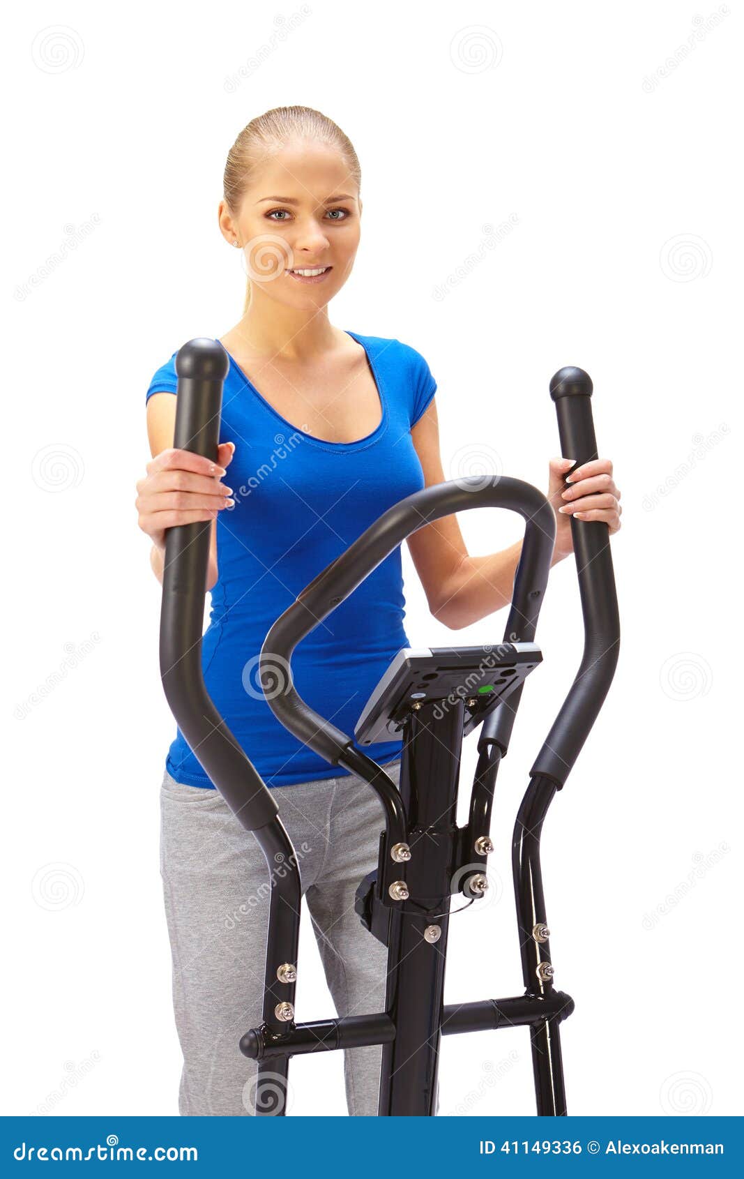 Young Woman Uses Elliptical Cross Trainer. Stock Photo Image of