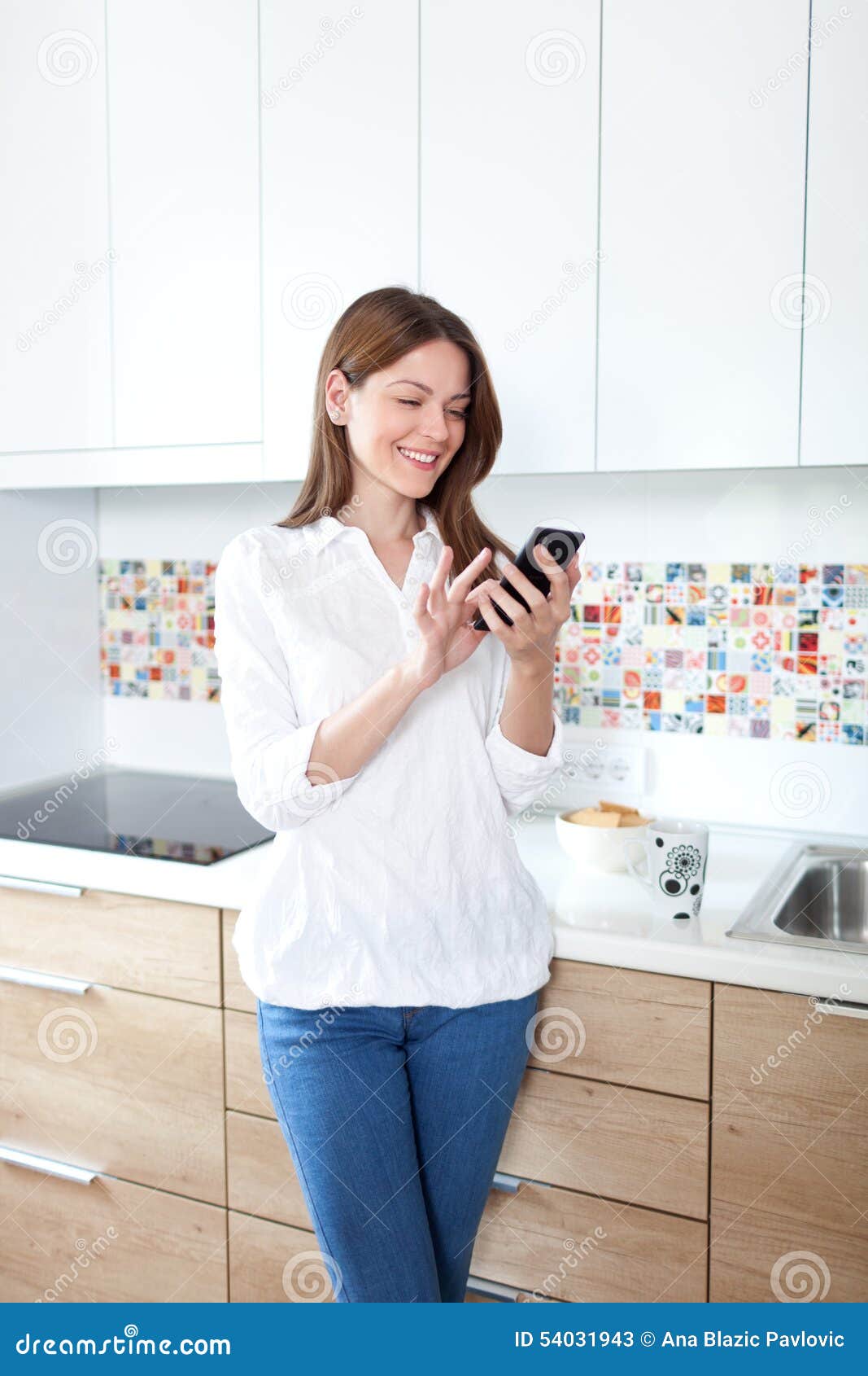 Young Woman Using Cell Phone in the Kitchen Stock Image Image of