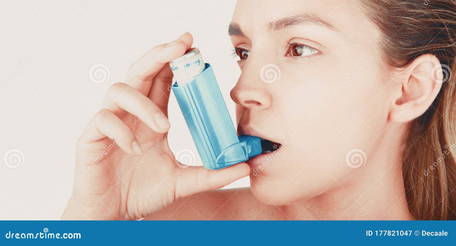 young woman using inhaler during asthmatic attack at home, closeup, white background