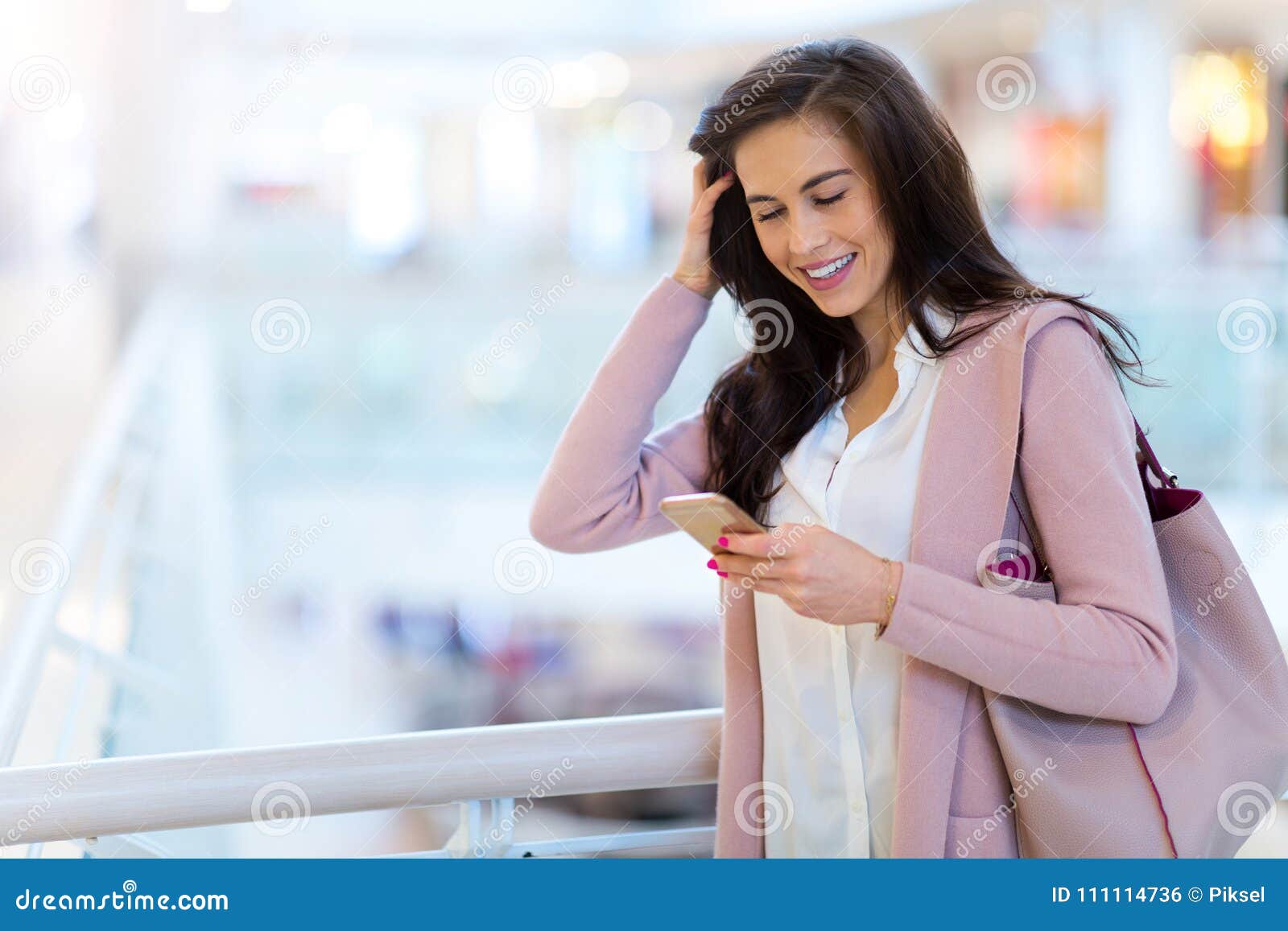 woman using mobile phone in shopping mall