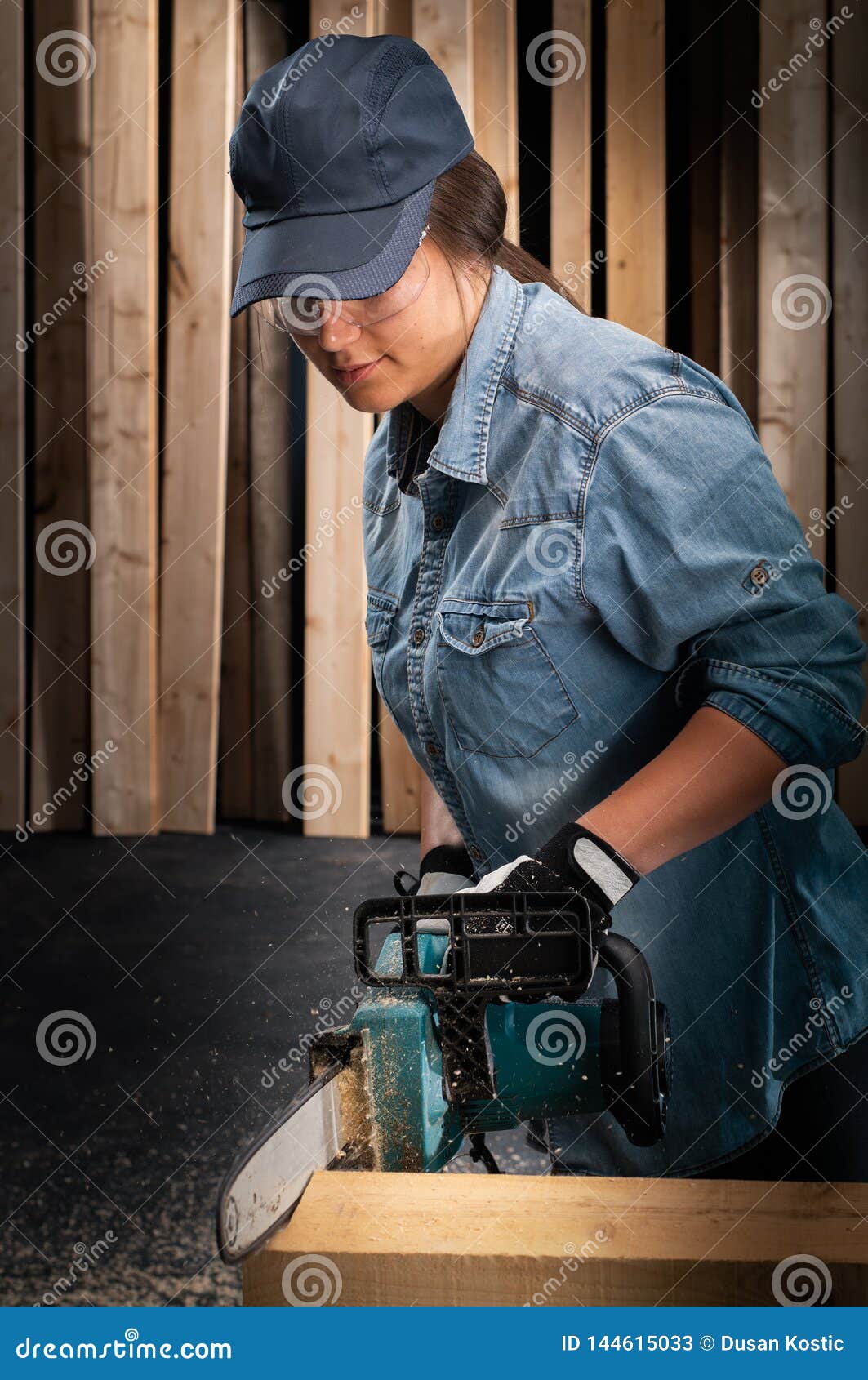 young woman  using modern electric  saw in the workshop
