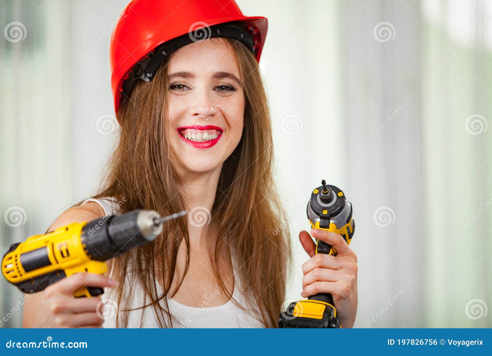 Woman using power driil for work at home. Young woman using power driil and screwdriver for work at home. Girl working at flat remodeling. Building, repair and renovation