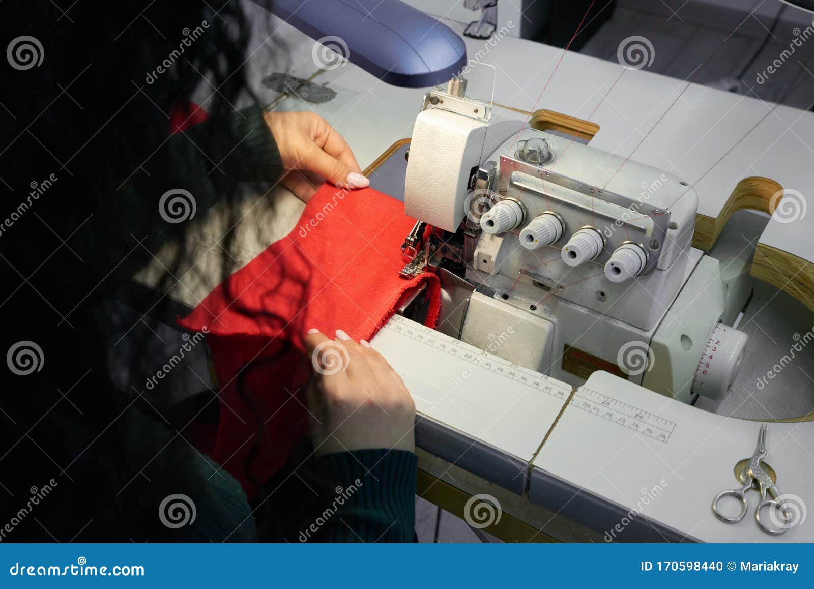 Young Woman Using Professional Overlock Sewing Machine in
