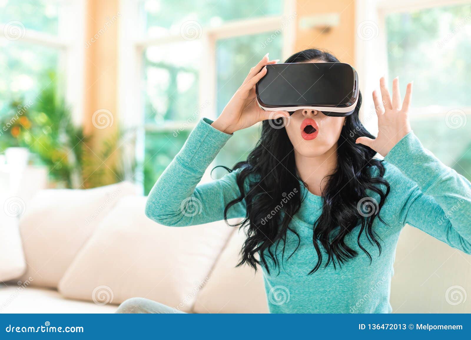 Young Woman Wearing Virtual Reality Headset In Studio 